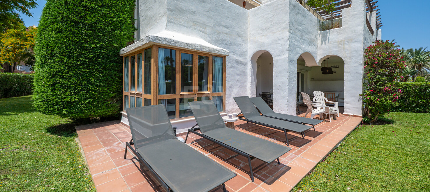Beachfront Corner Apartment with Expansive Garden in Premier Gated Community