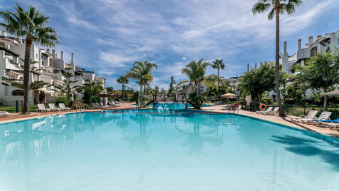 Beachfront Corner Apartment with Expansive Garden in Premier Gated Community