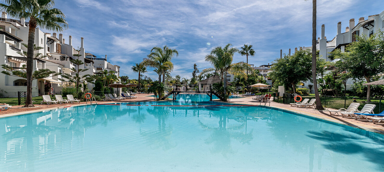 Beachfront Corner Apartment with Expansive Garden in Premier Gated Community