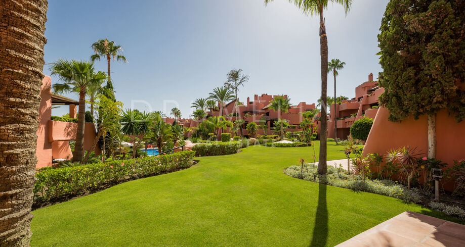 Renovated beachfront apartment in Torre Bermeja with garden views, terrace, and top amenities.