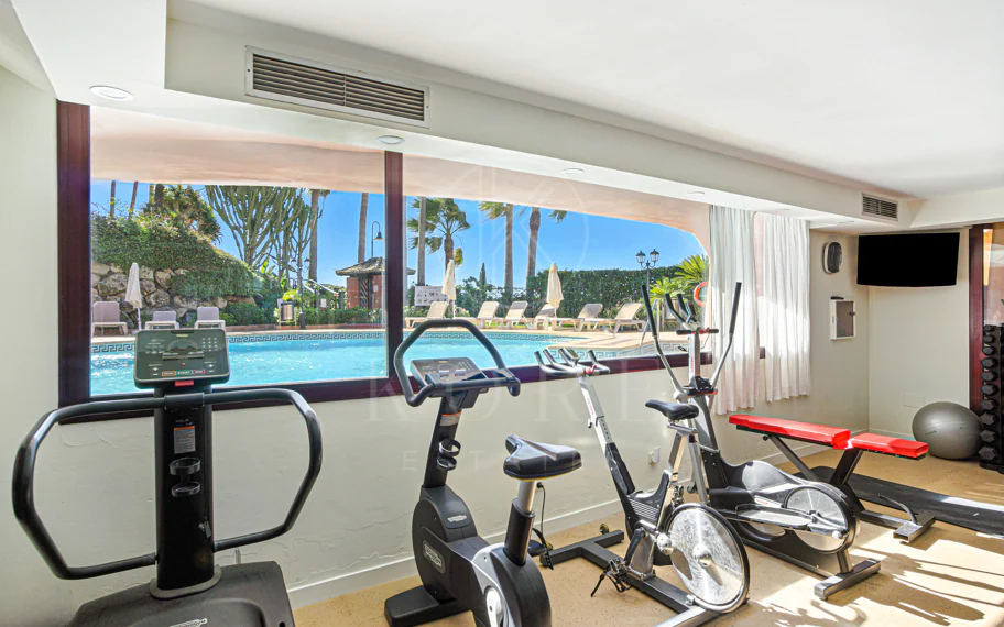 Impeccably renovated, south facing beach front, garden apartment located in the exclusive Menara Beach community on the sought-after New Golden Mile