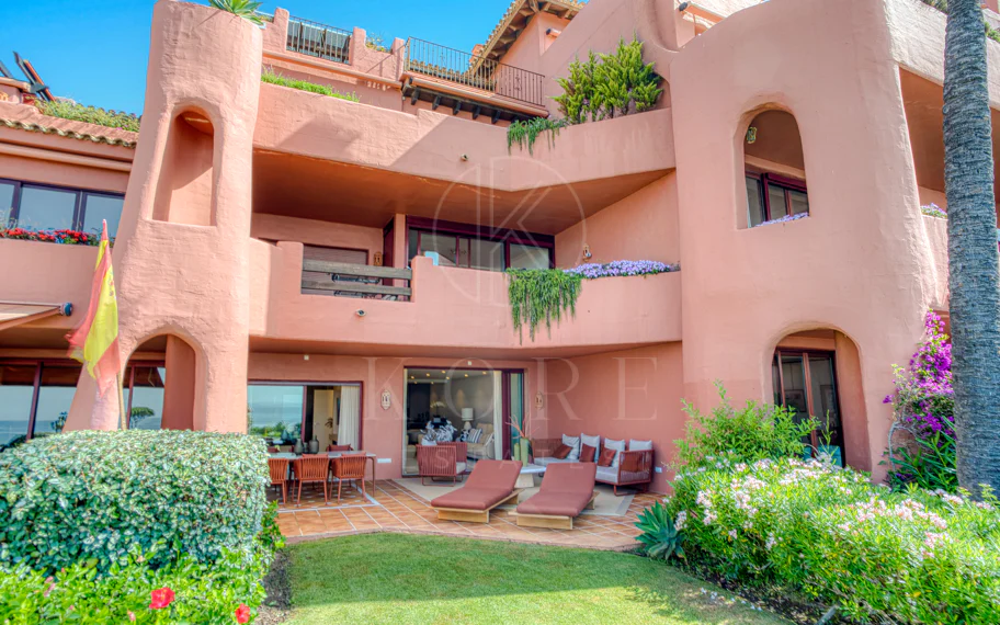 Impeccably renovated, south facing beach front, garden apartment located in the exclusive Menara Beach community on the sought-after New Golden Mile