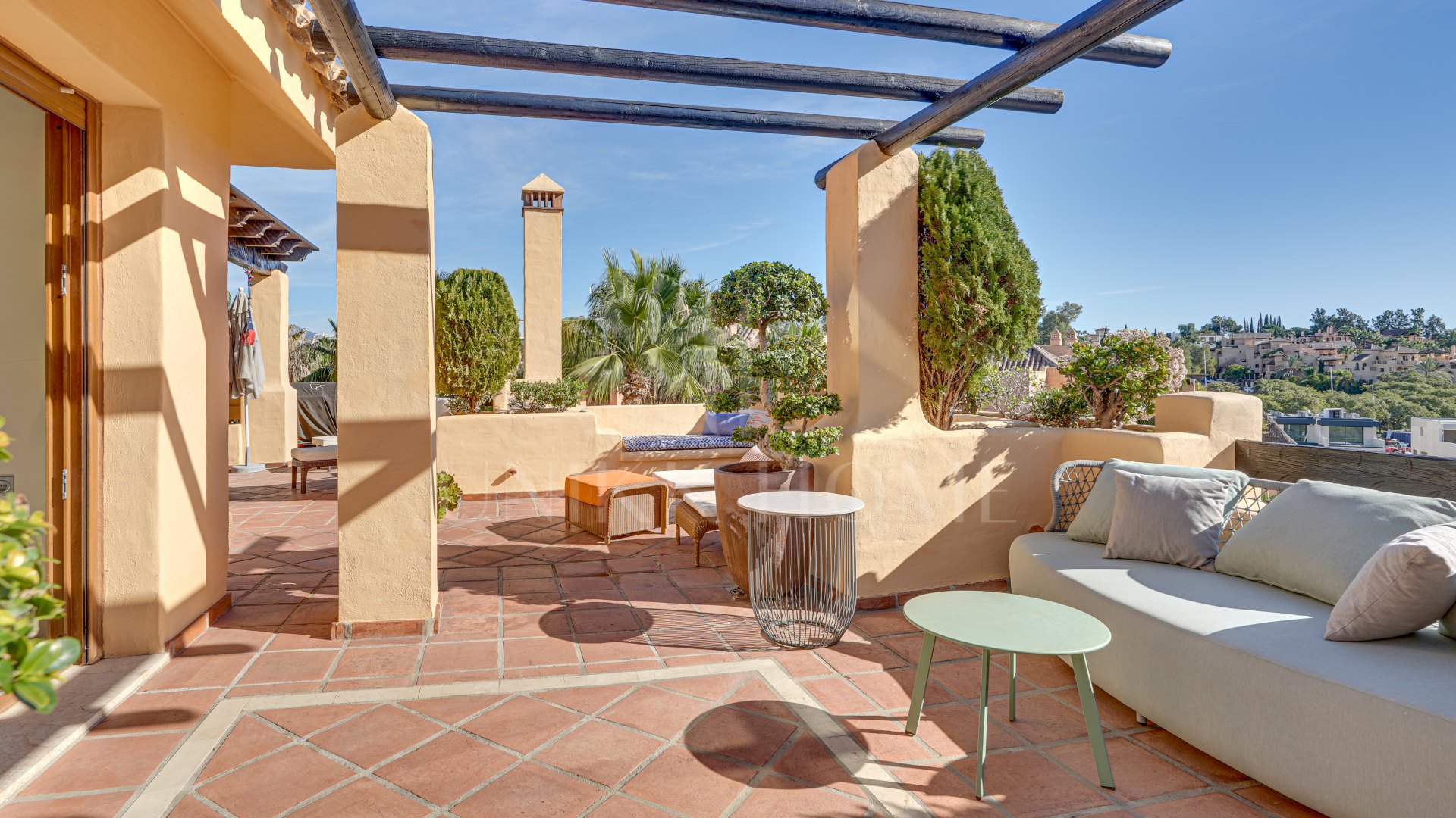 Mediterranean-style duplex penthouse with multiple terraces and a rooftop terrace with a private sauna and barbecue area