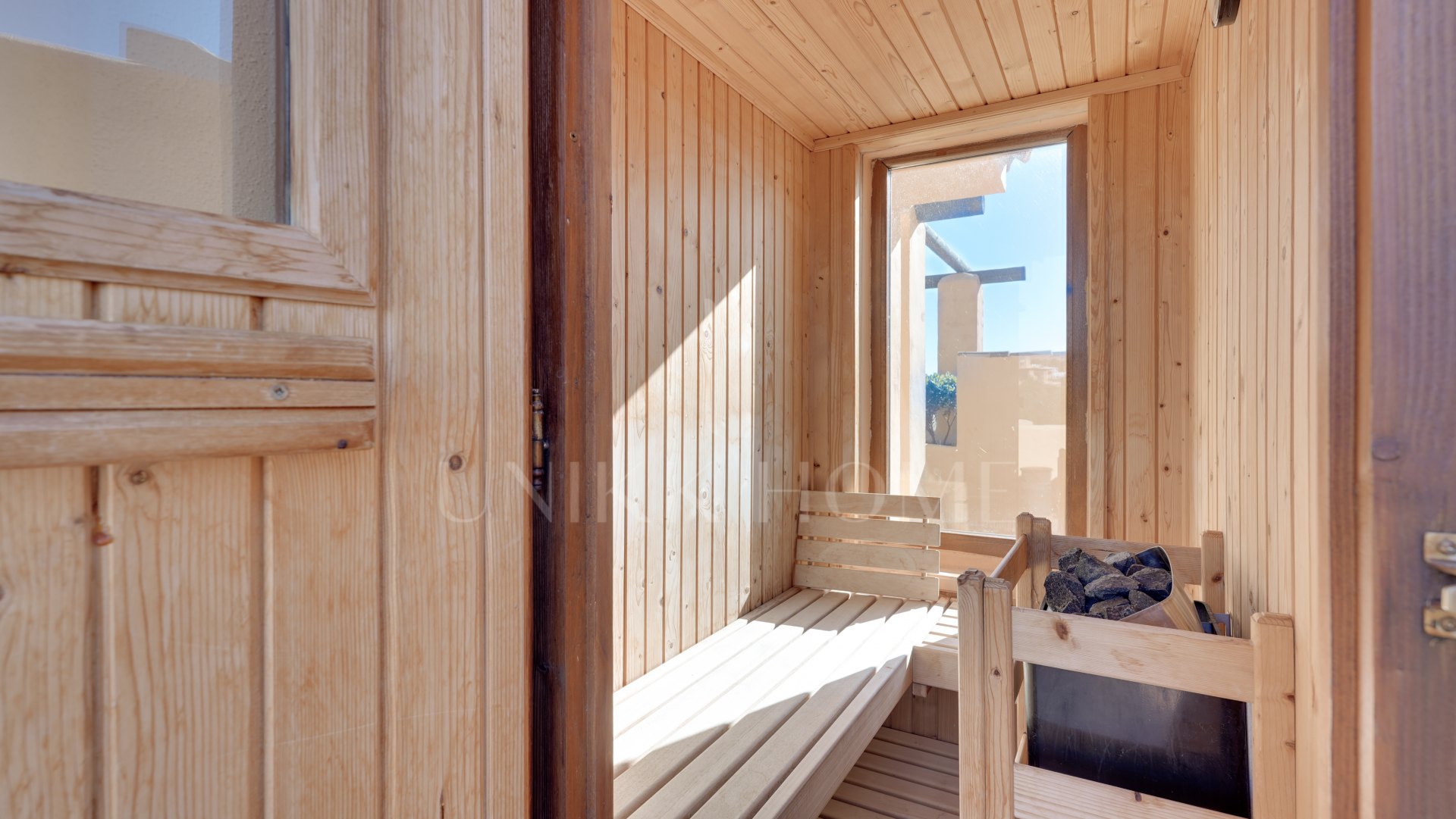 Mediterranean-style duplex penthouse with multiple terraces and a rooftop terrace with a private sauna and barbecue area