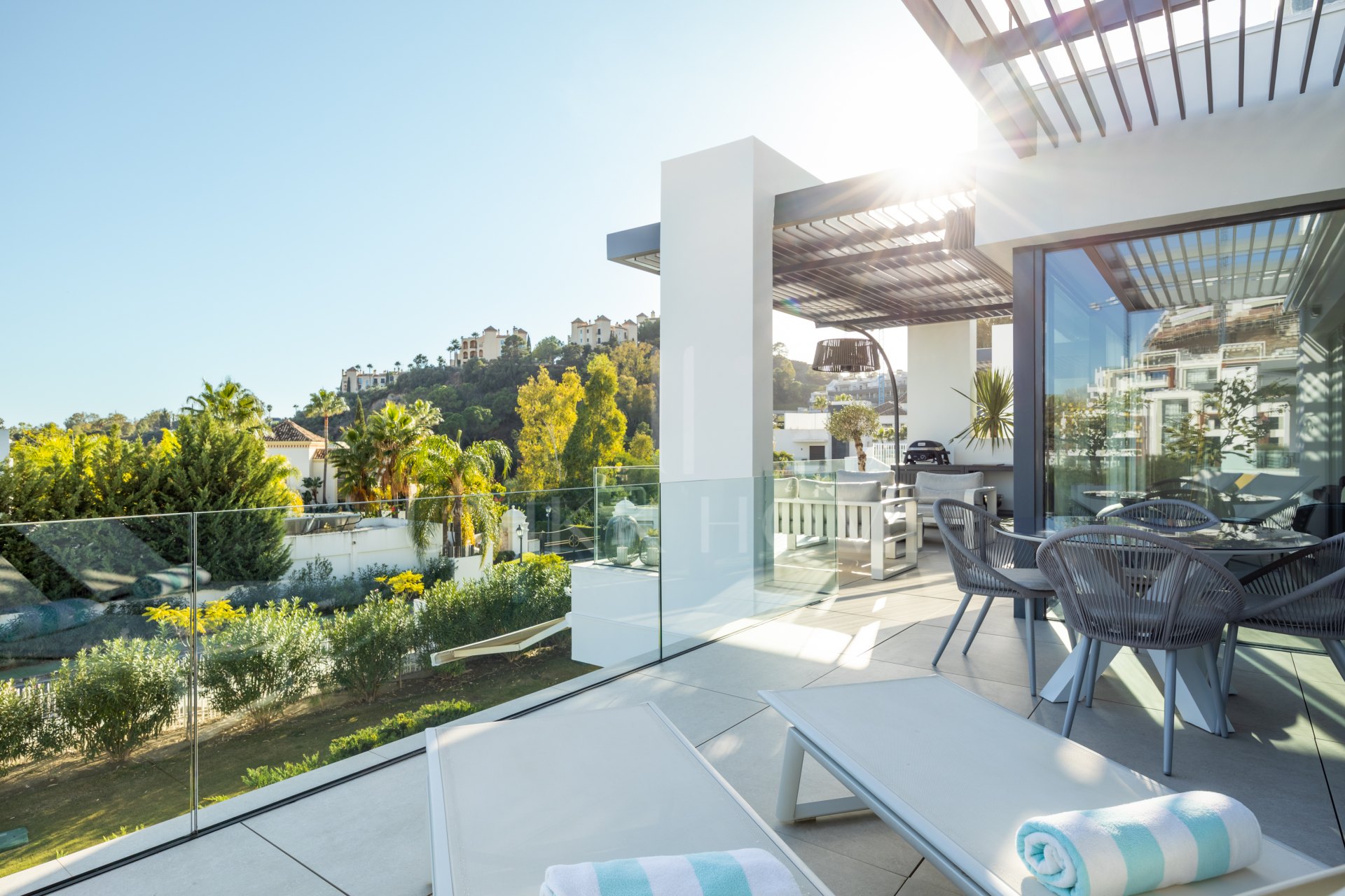 Elegant 2-bed, 2-bath apartment in Marbella’s Golf Valley with 112m² interior, 43m² terrace, luxury finishes, pools, gym, concierge & 2 parking spaces.