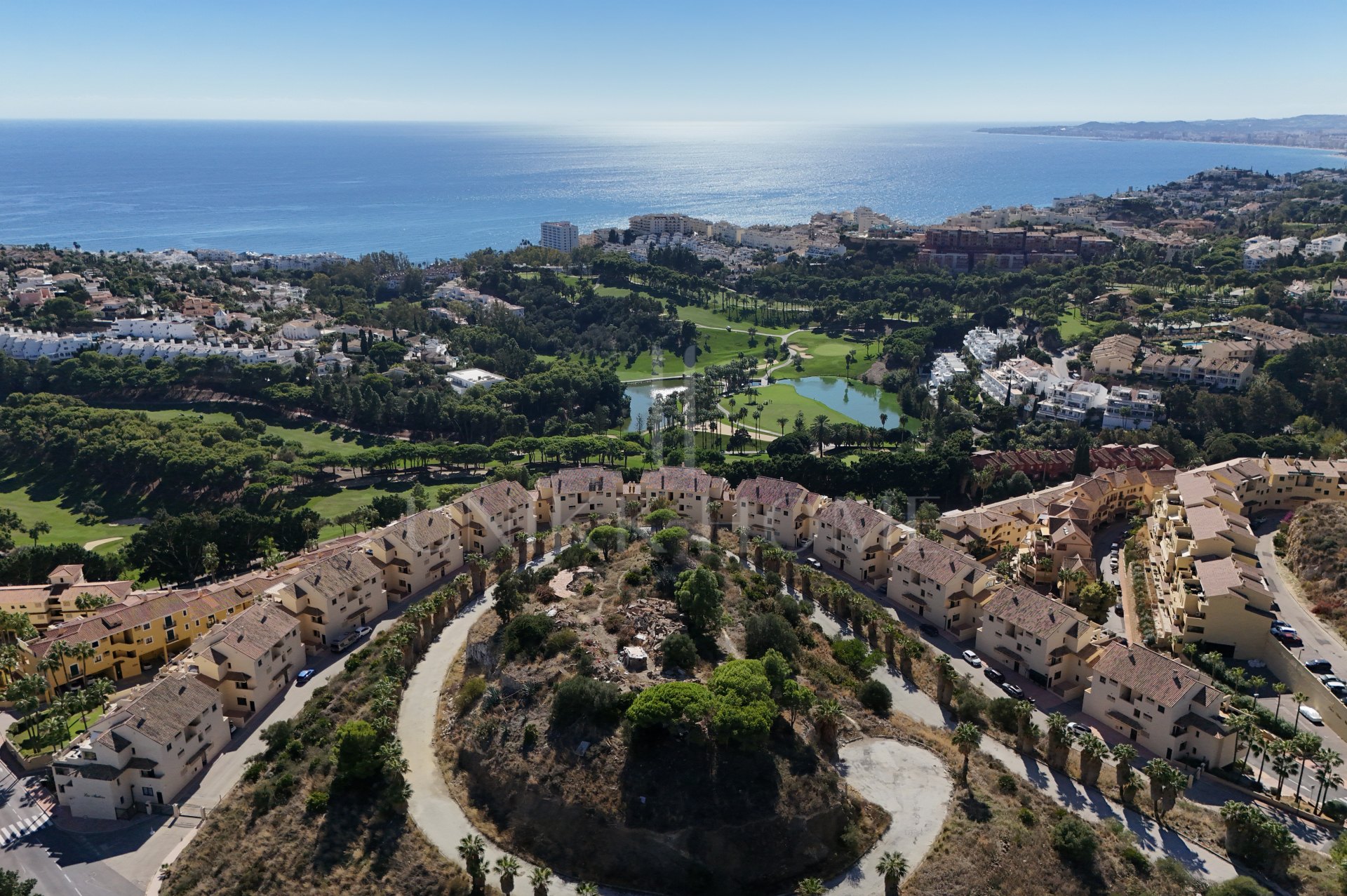 A furnished southwest-facing duplex penthouse in Torrequebrada with panoramic sea and golf views, expansive terraces and two garage parking spaces.