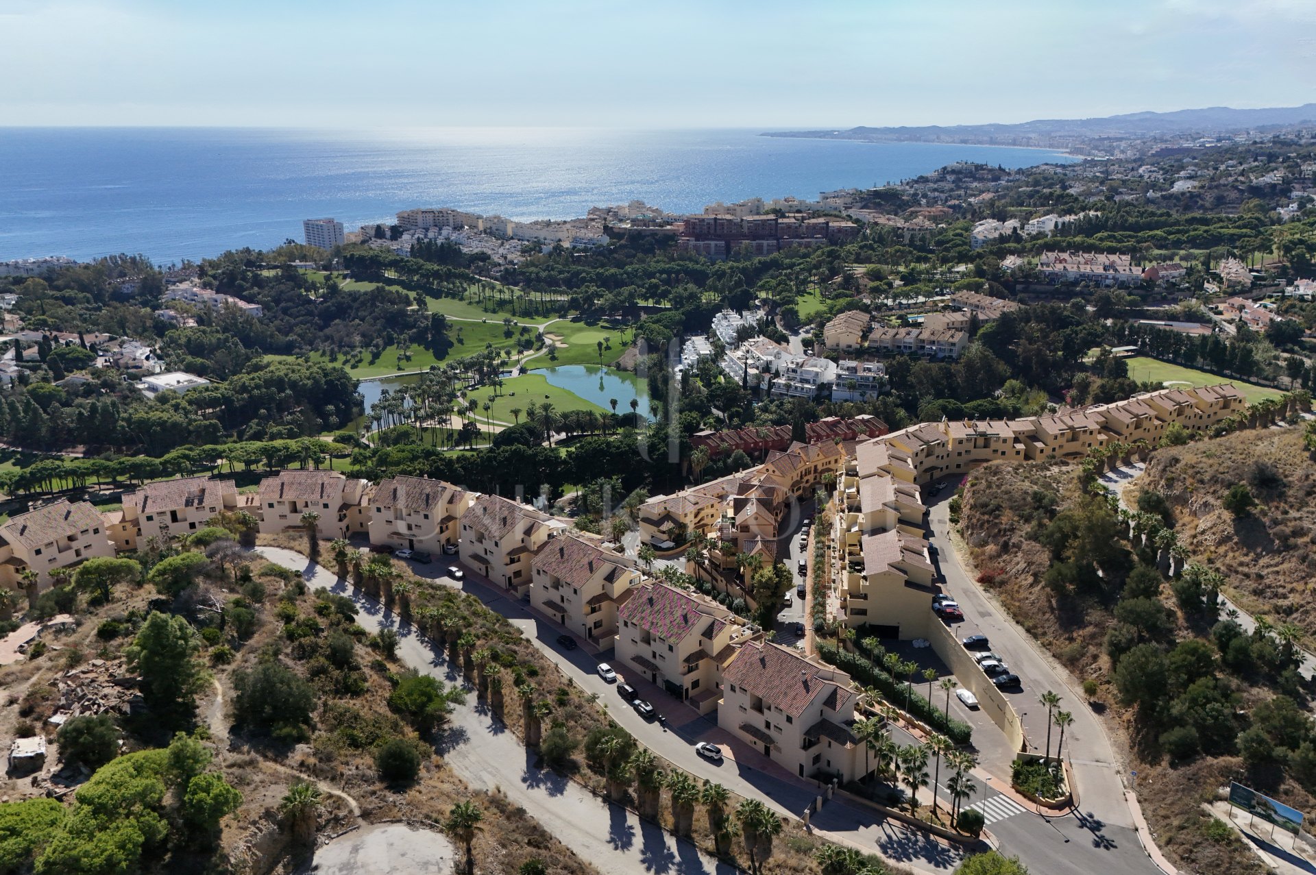 A furnished southwest-facing duplex penthouse in Torrequebrada with panoramic sea and golf views, expansive terraces and two garage parking spaces.