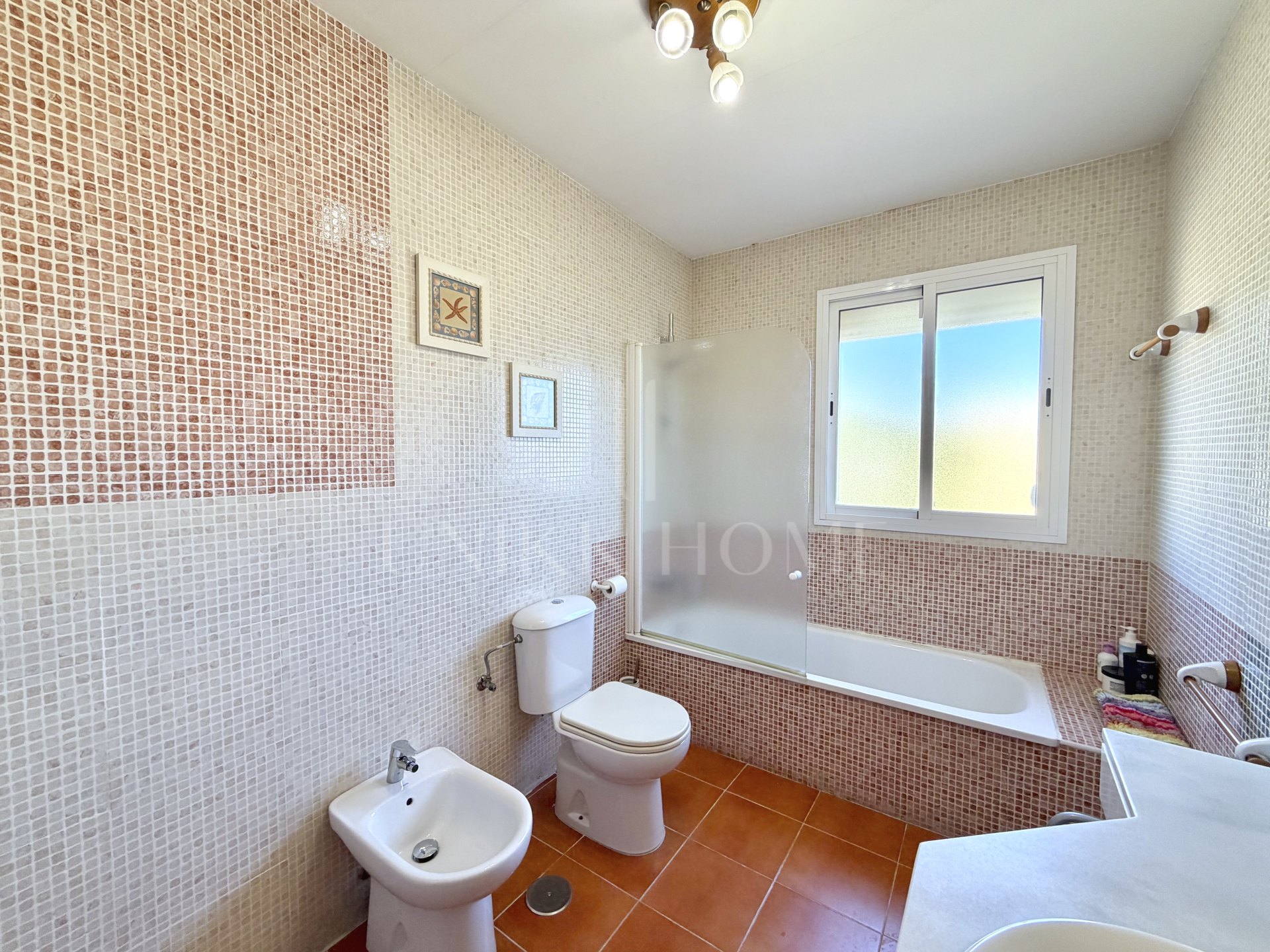 Town house in Cancelada, Estepona East with sea and mountain views, private garden, roof terrace, communal pool and garage for two cars.