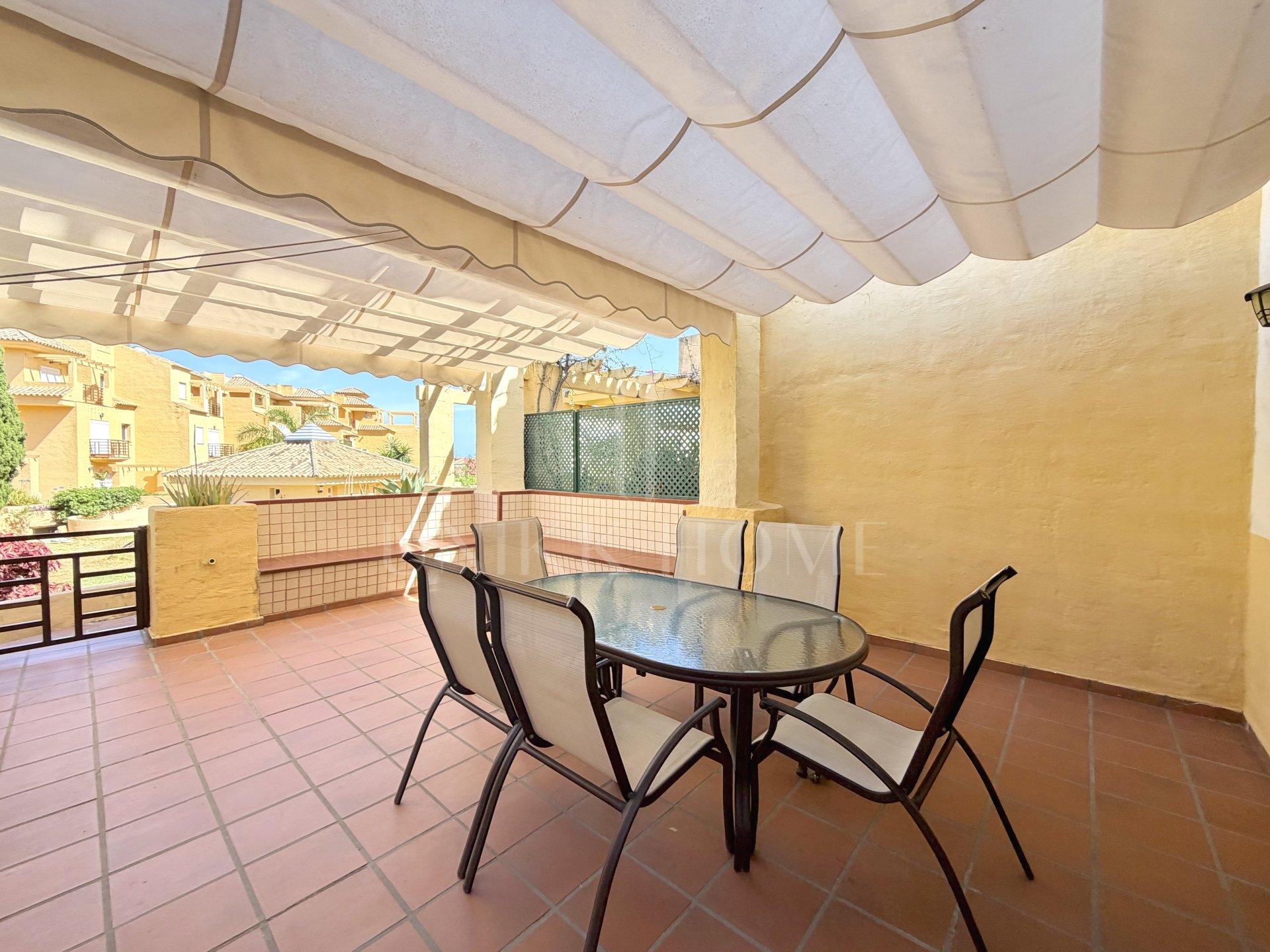 Town house in Cancelada, Estepona East with sea and mountain views, private garden, roof terrace, communal pool and garage for two cars.