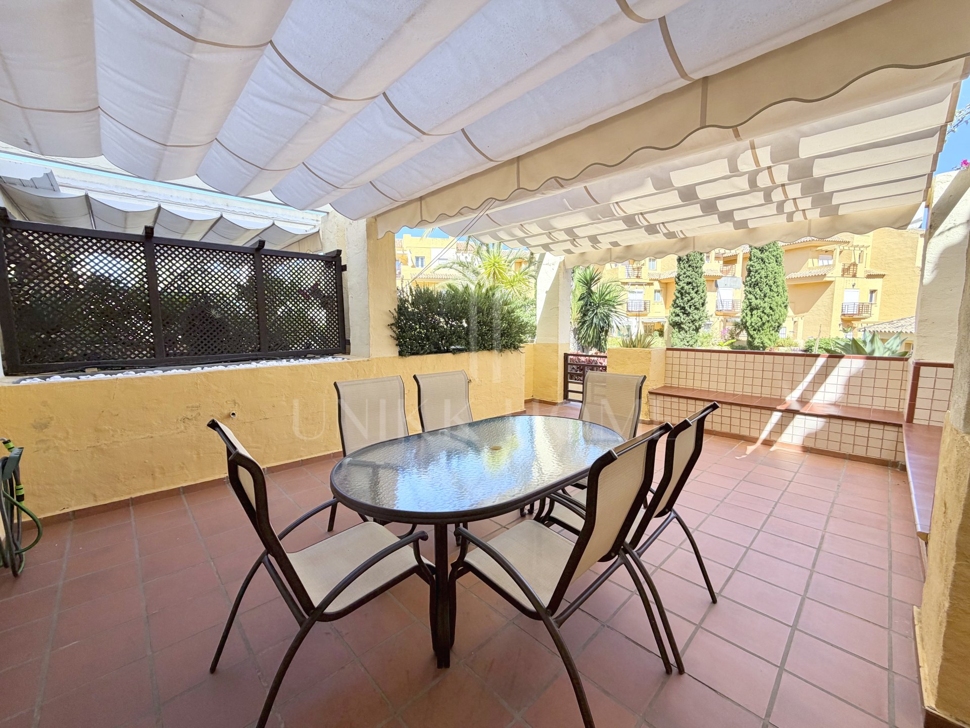 Town house in Cancelada, Estepona East with sea and mountain views, private garden, roof terrace, communal pool and garage for two cars.