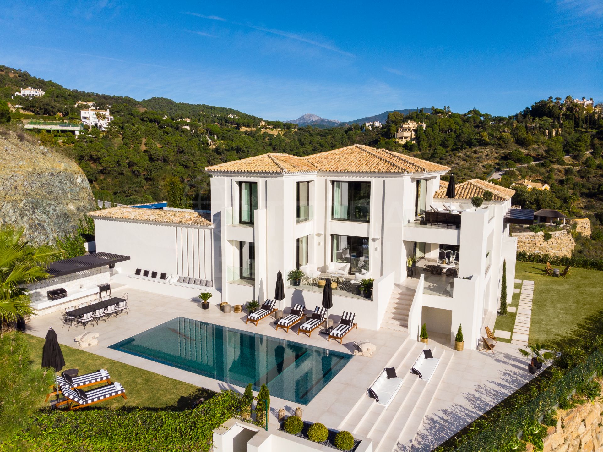 A striking trophy residence with scenic views for sale in the affluent private community of El Madroñal, Benahavis