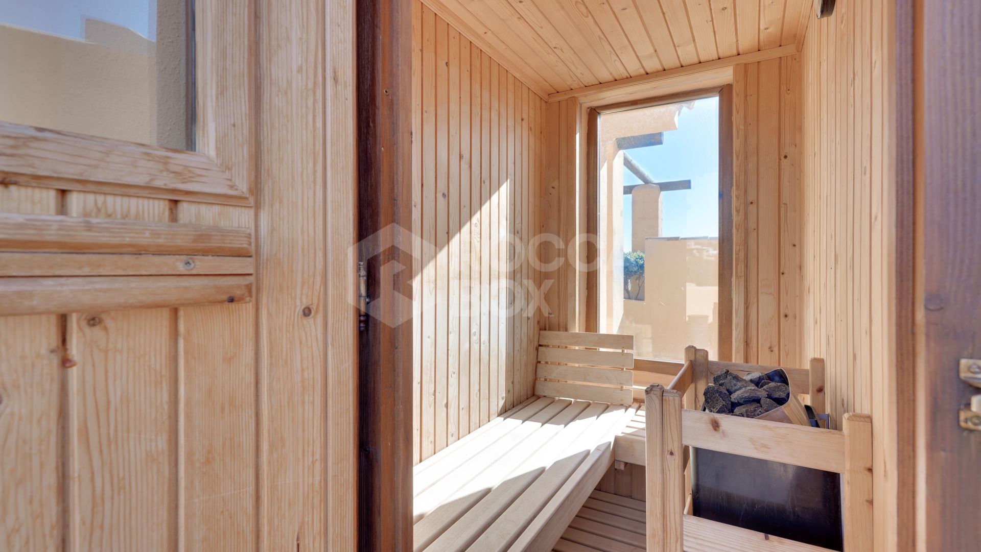 Mediterranean-style duplex penthouse with multiple terraces and a rooftop terrace with a private sauna and barbecue area