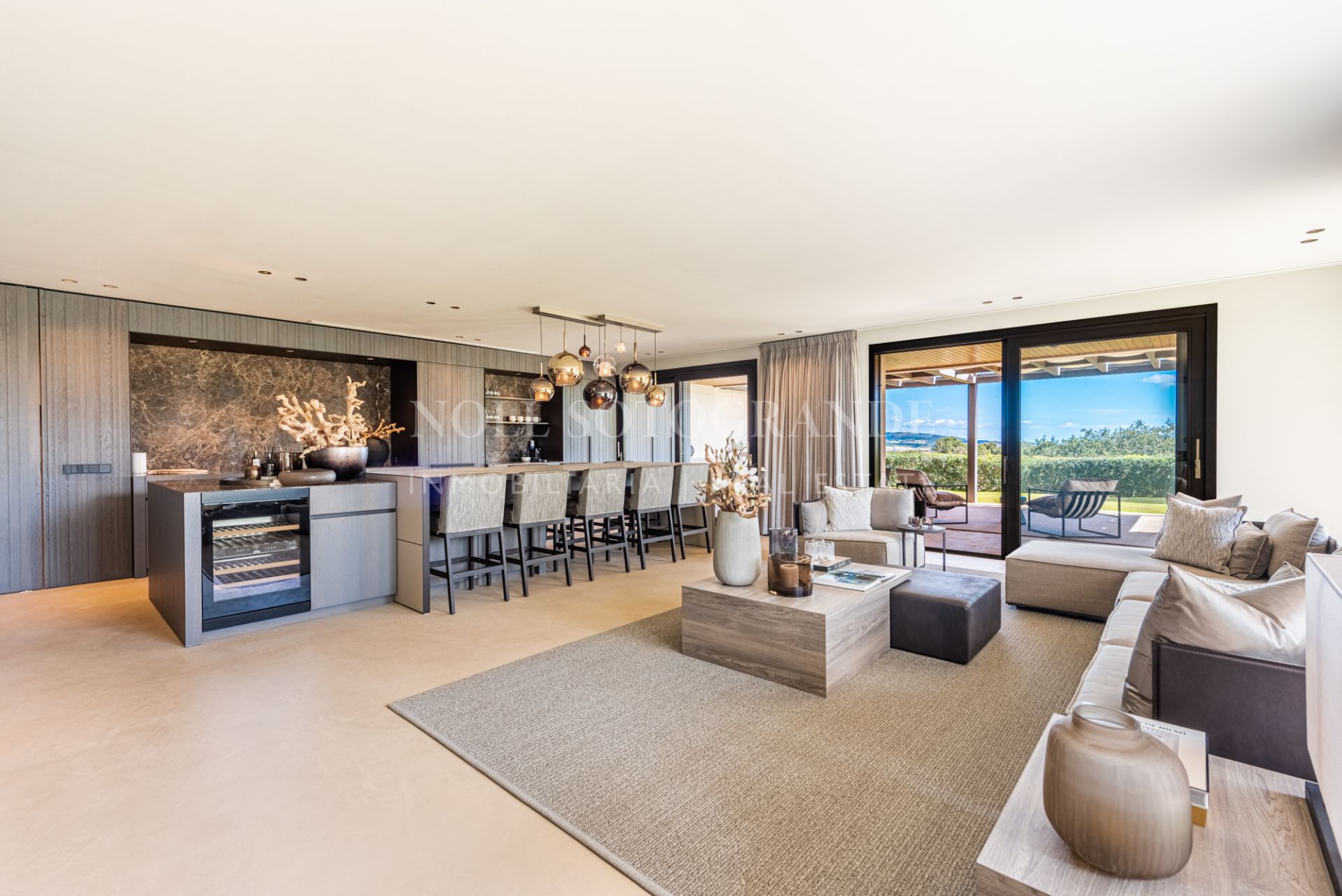 Depersonalized living room - kitchen area of a luxury home for sale in Sotogrande