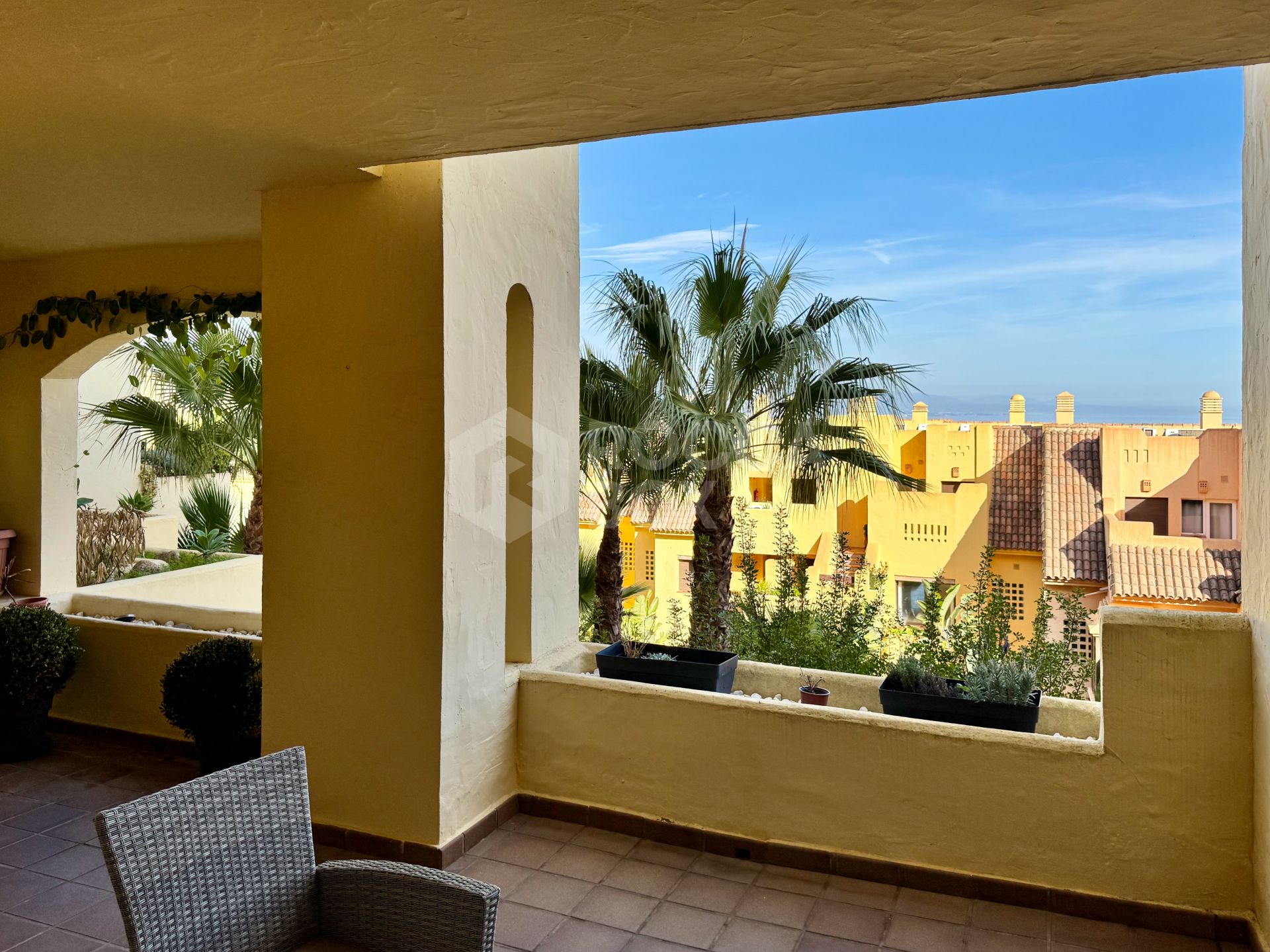 Elevated ground-floor apartment with terrace and open outlook, Manilva