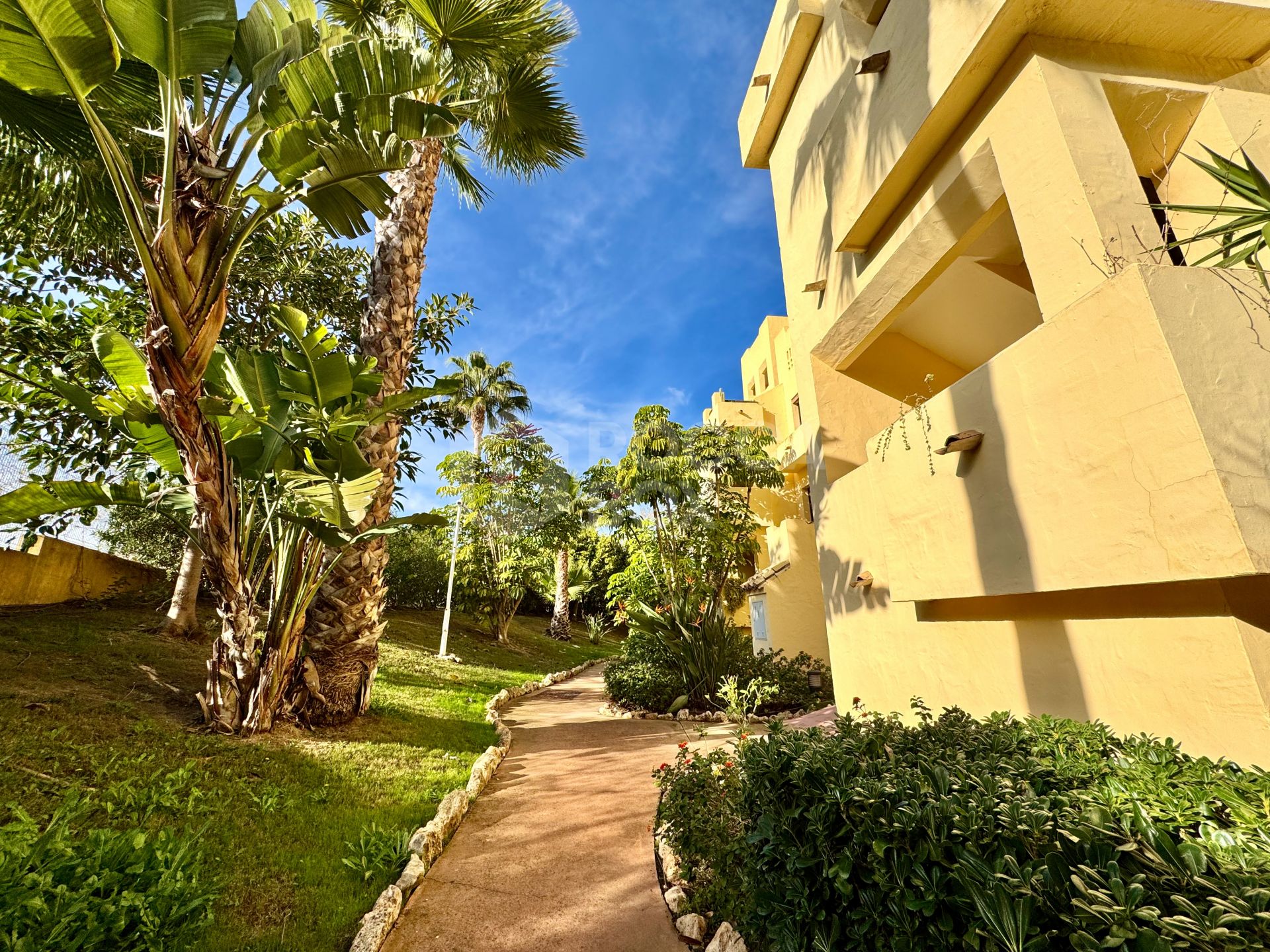 Elevated ground-floor apartment with terrace and open outlook, Manilva