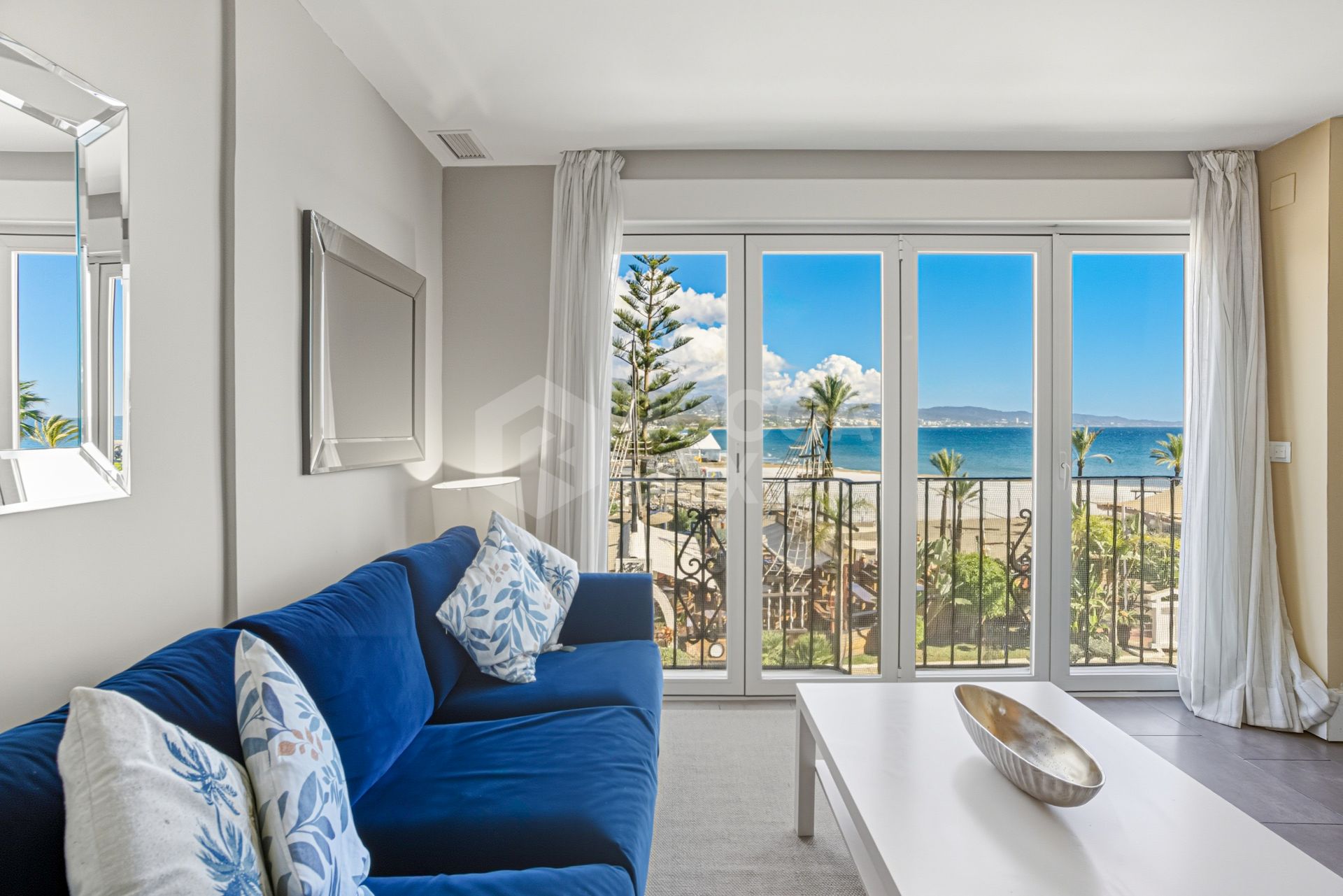 Two-bedroom, beachfront apartment with sea and mountain views, located in the heart of Puerto Banús.