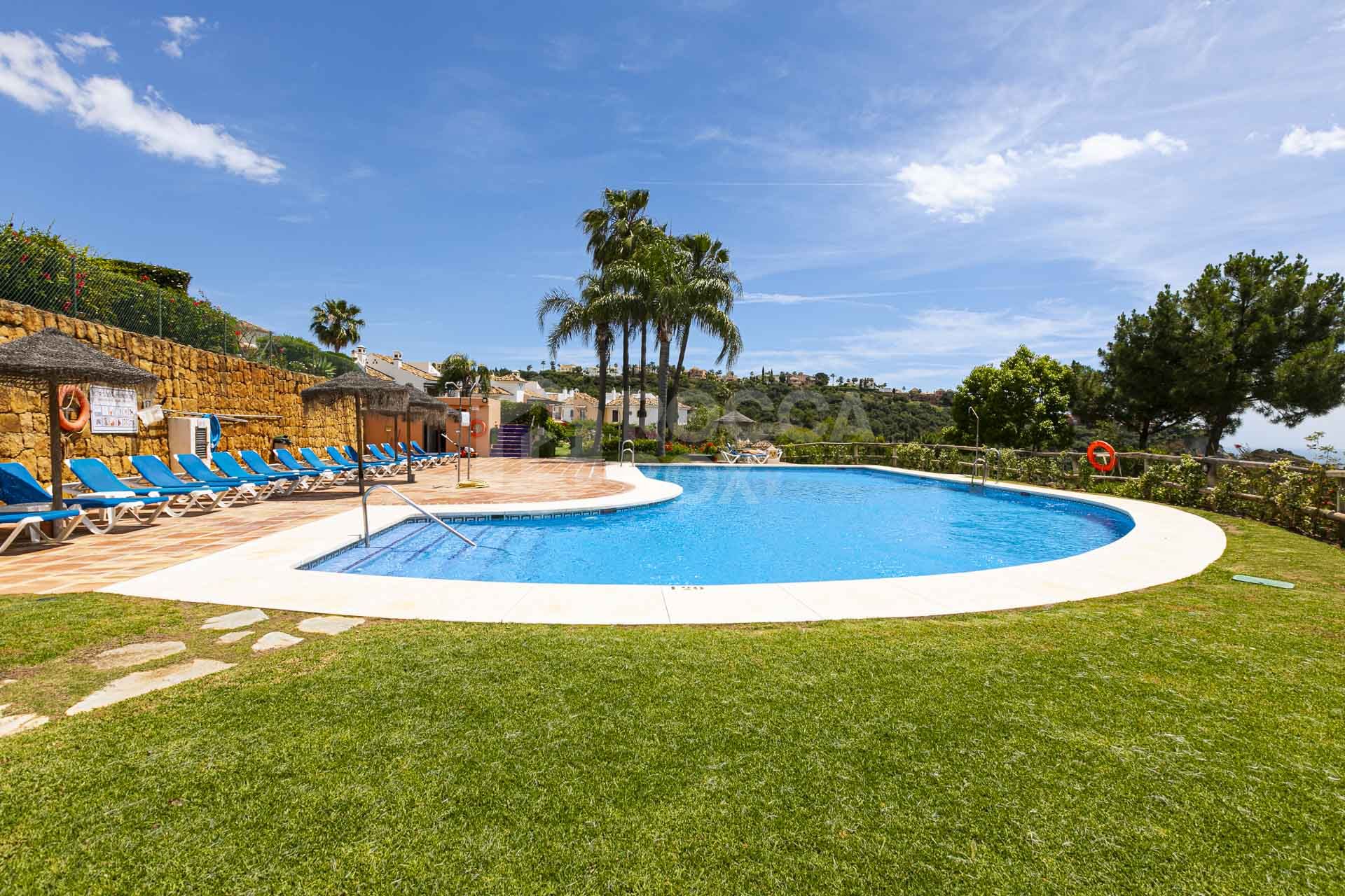 Beautiful south-facing, four bedroom townhouse in Los Almendros, part of the secure Los Arqueros Golf community in Benahavís