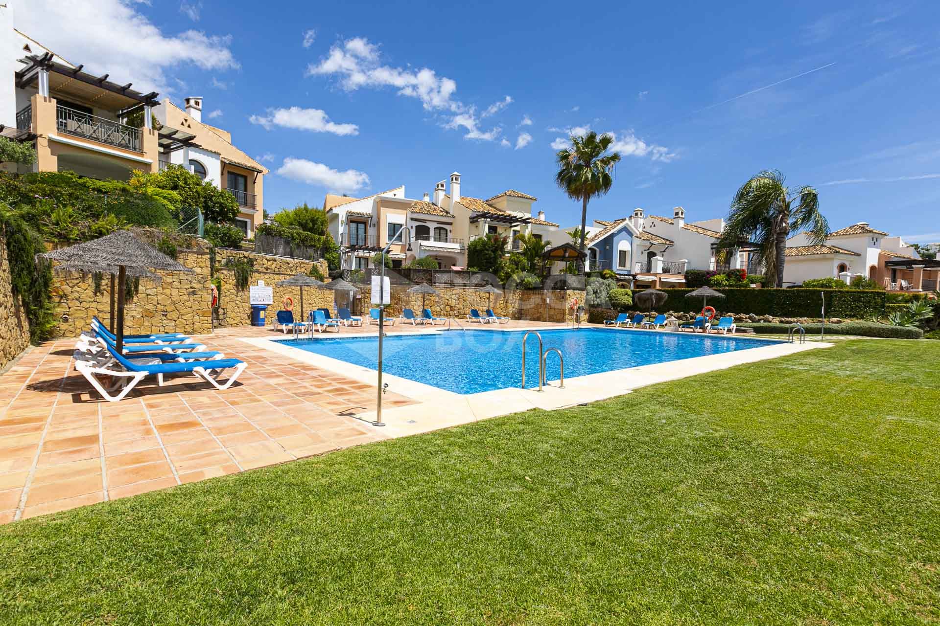 Beautiful south-facing, four bedroom townhouse in Los Almendros, part of the secure Los Arqueros Golf community in Benahavís