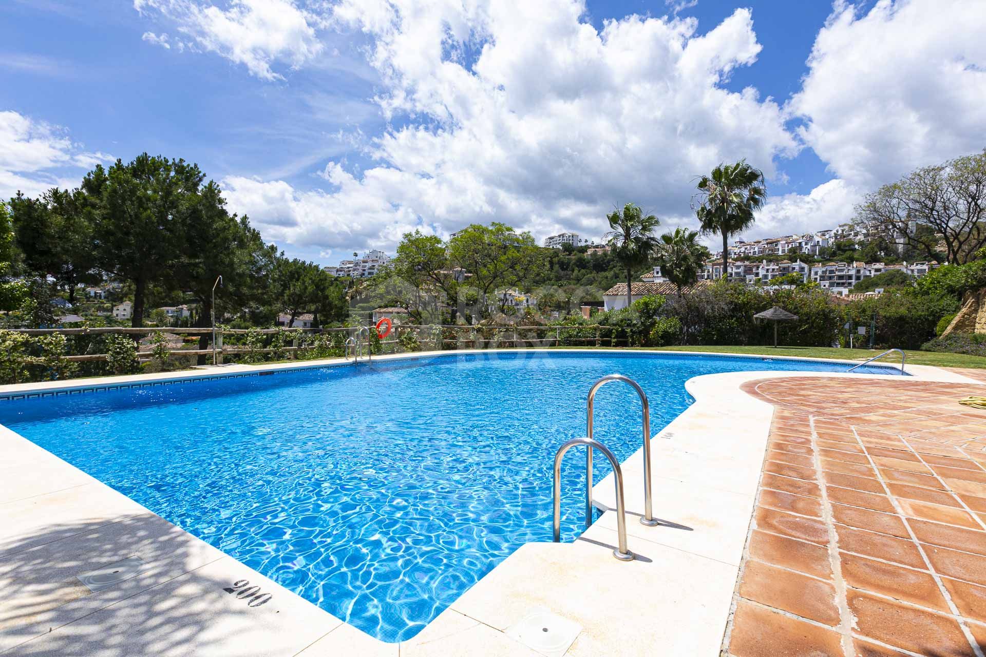 Beautiful south-facing, four bedroom townhouse in Los Almendros, part of the secure Los Arqueros Golf community in Benahavís