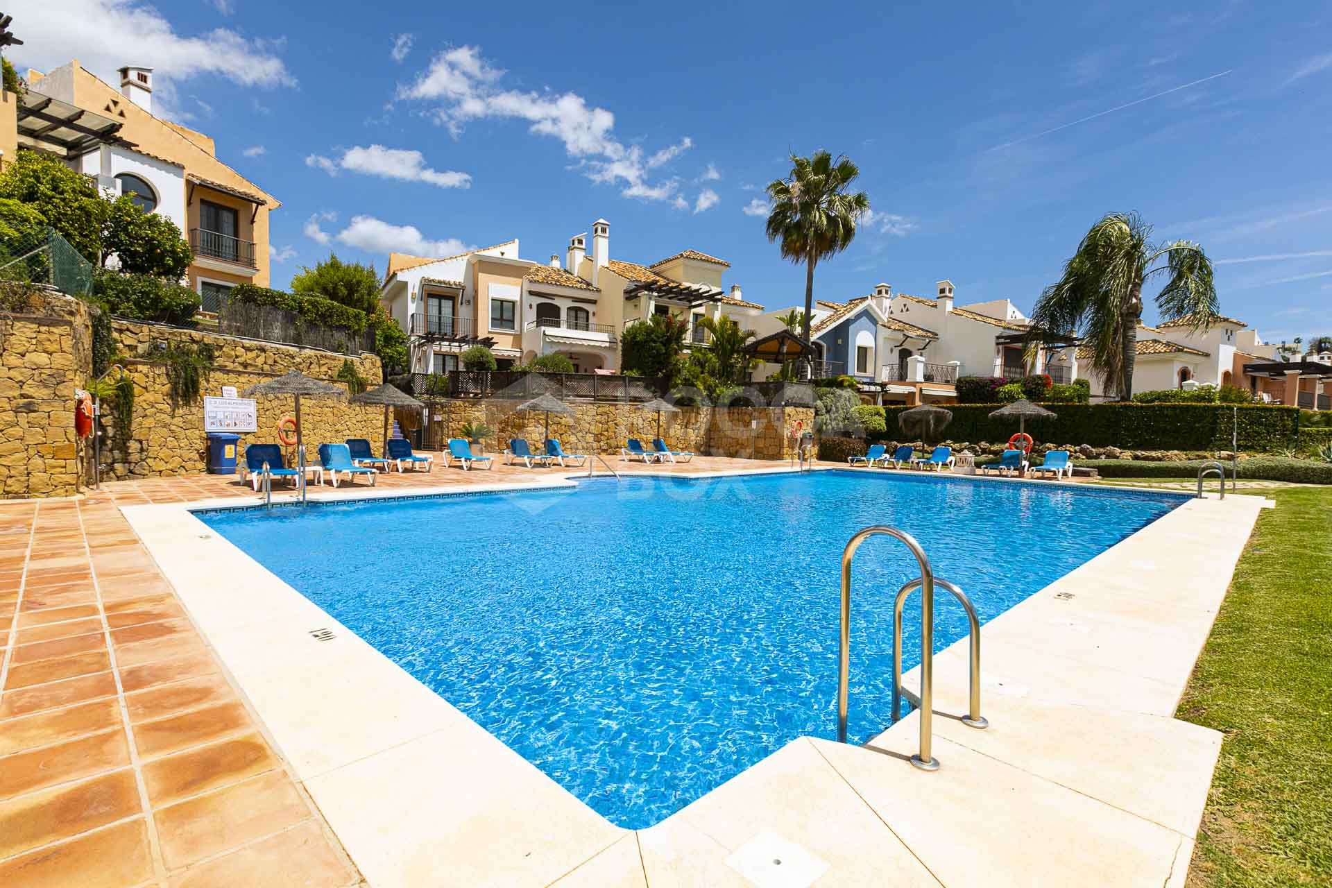 Beautiful south-facing, four bedroom townhouse in Los Almendros, part of the secure Los Arqueros Golf community in Benahavís