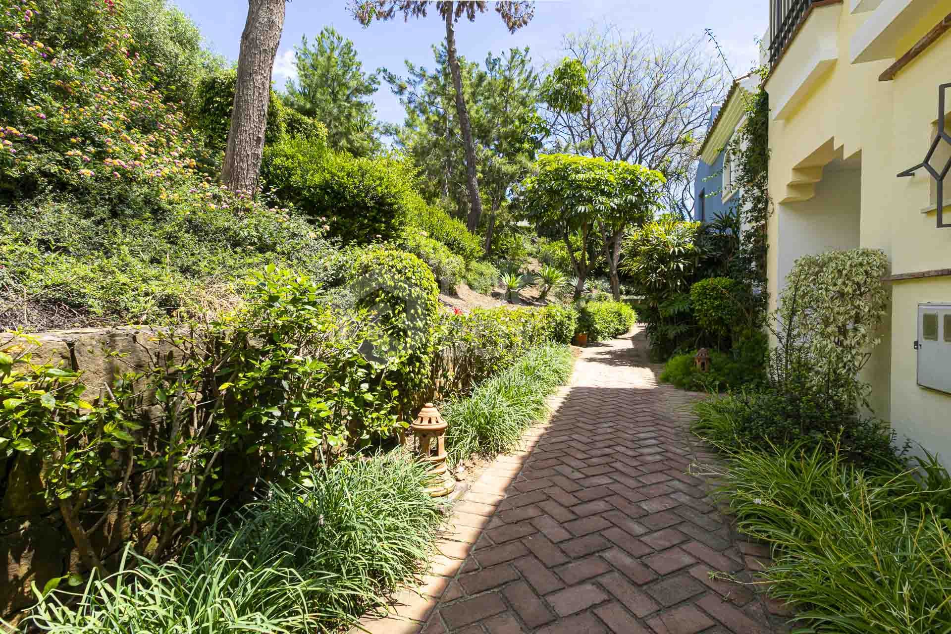 Beautiful south-facing, four bedroom townhouse in Los Almendros, part of the secure Los Arqueros Golf community in Benahavís