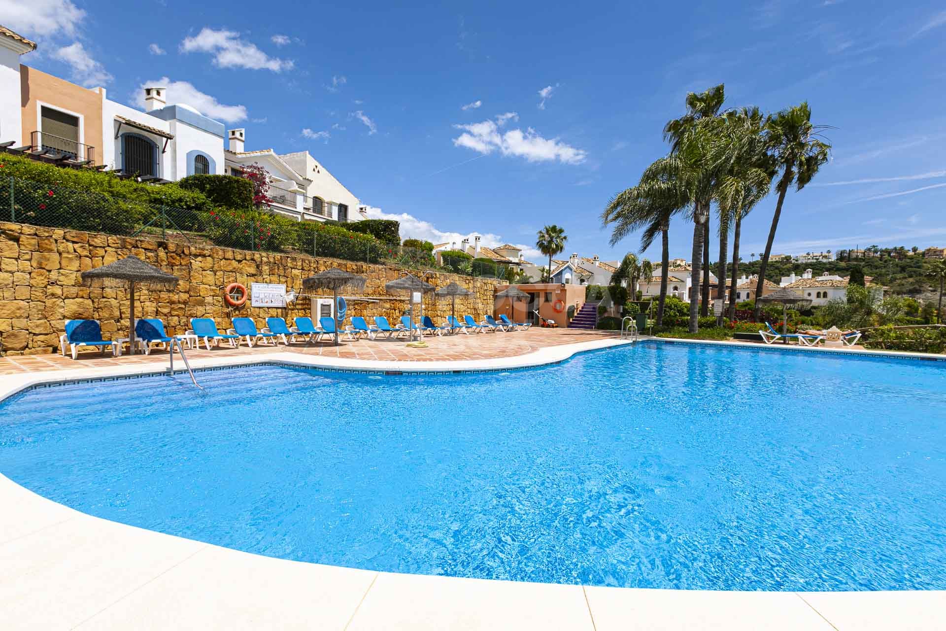 Beautiful south-facing, four bedroom townhouse in Los Almendros, part of the secure Los Arqueros Golf community in Benahavís