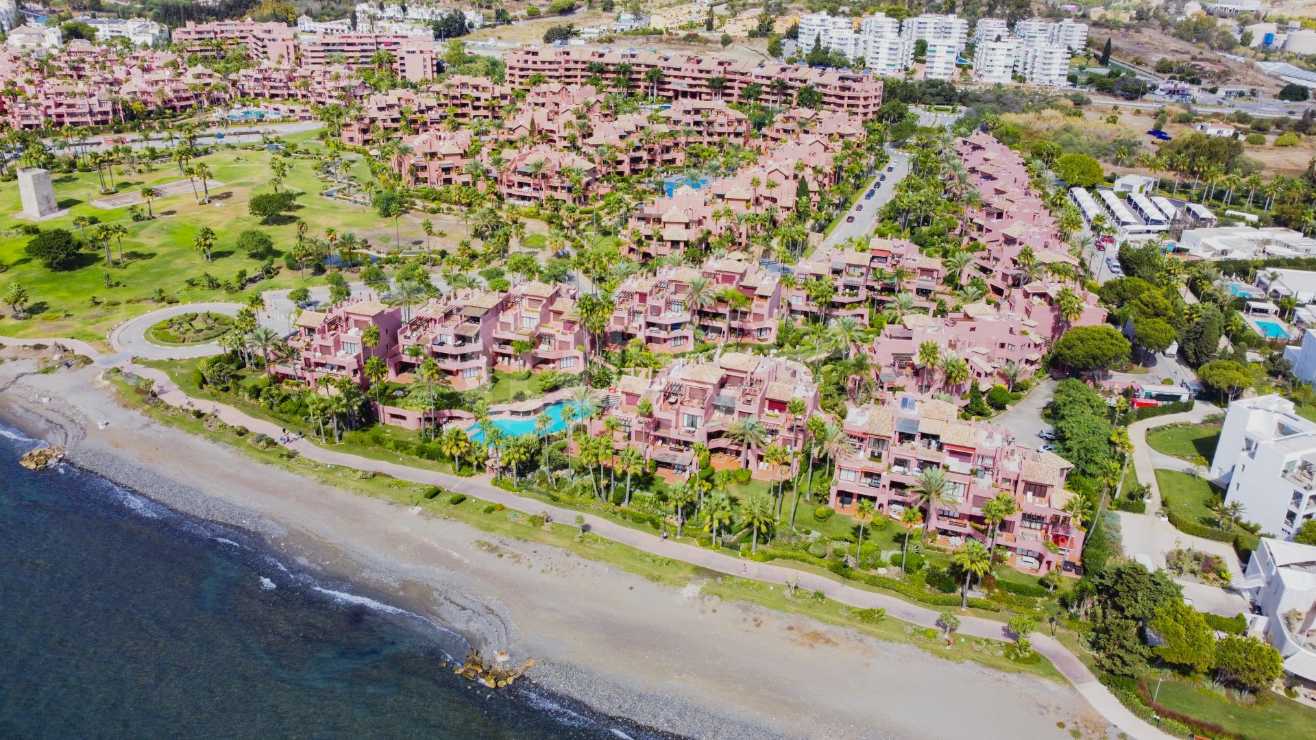 Impeccably renovated, south facing beach front, garden apartment located in the exclusive Menara Beach community on the sought-after New Golden Mile