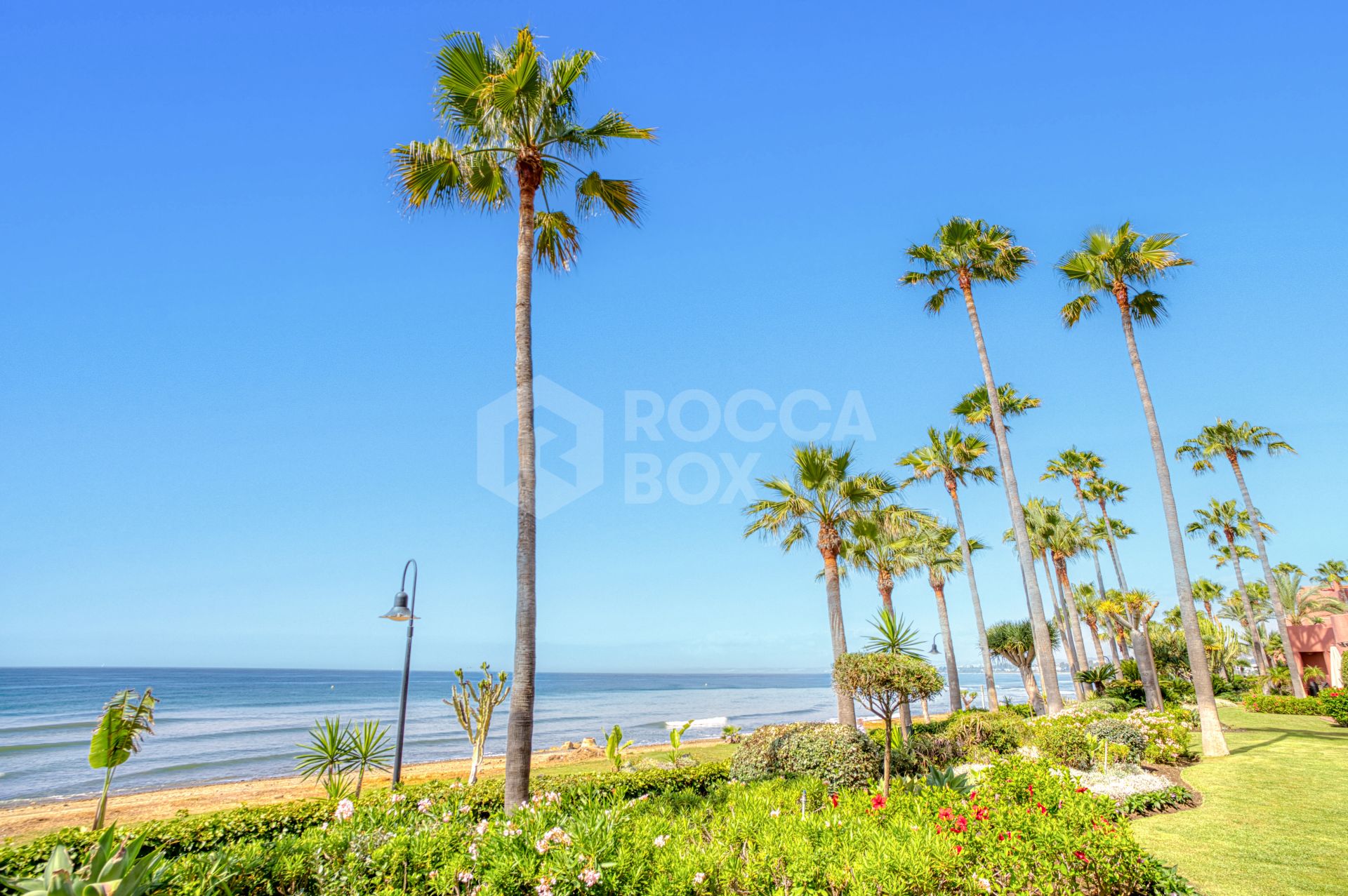 Impeccably renovated, south facing beach front, garden apartment located in the exclusive Menara Beach community on the sought-after New Golden Mile