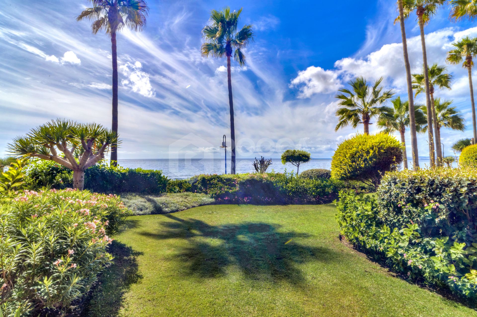 Impressive two bedroom, beach front ground floor apartment located in the luxury gated community of Menara Beach, Estepona.