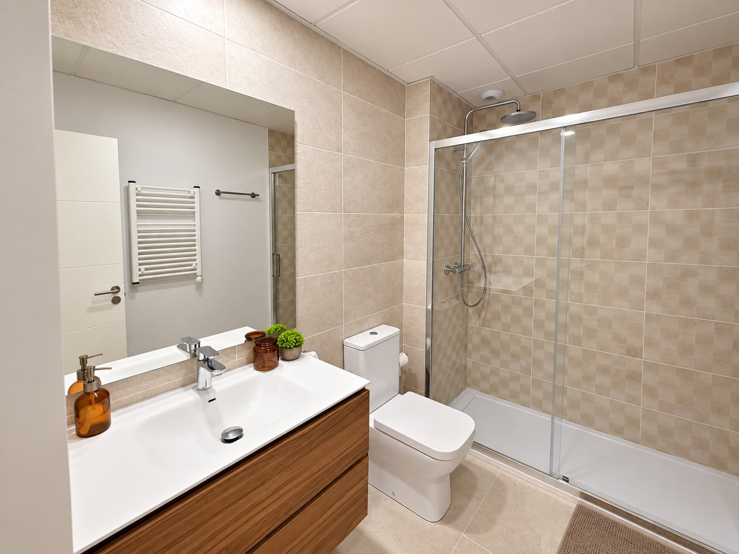 Bathroom with a modern vanity sink, mirror, toilet, and a glass-enclosed shower stall.