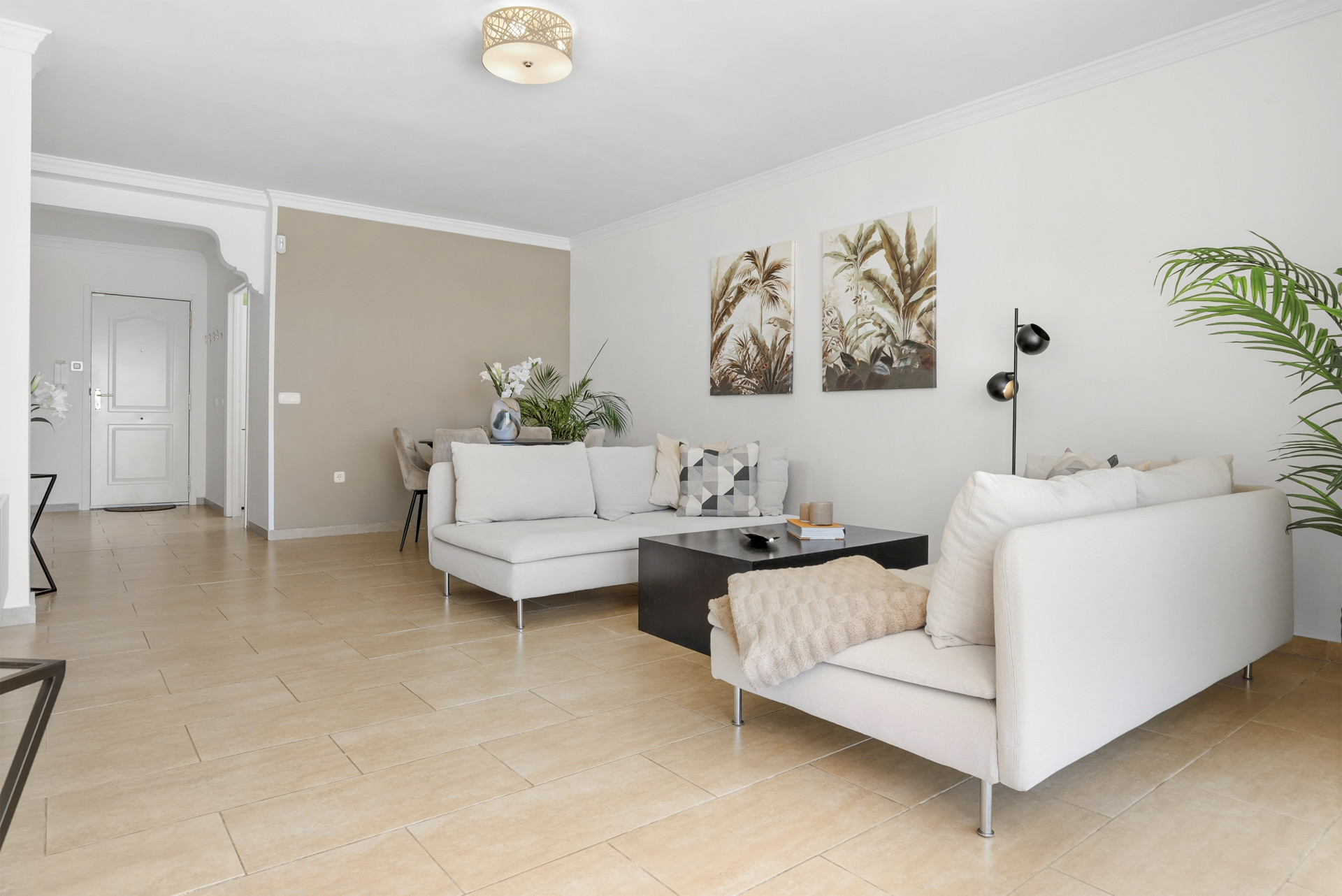 Living room featuring two sofas, a coffee table, and decorative wall art.