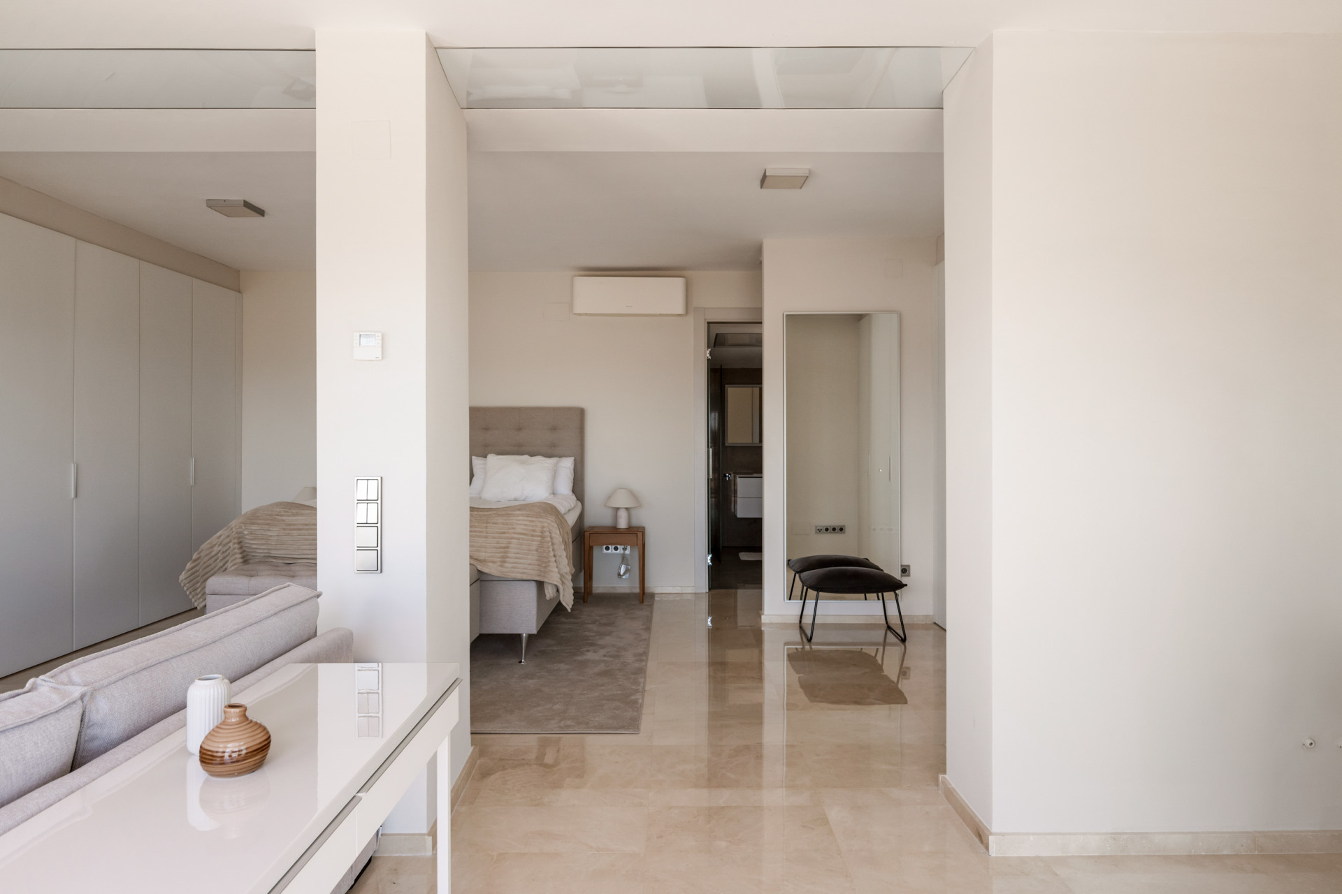 Spacious bedroom with a king-sized bed and modern closet designs.