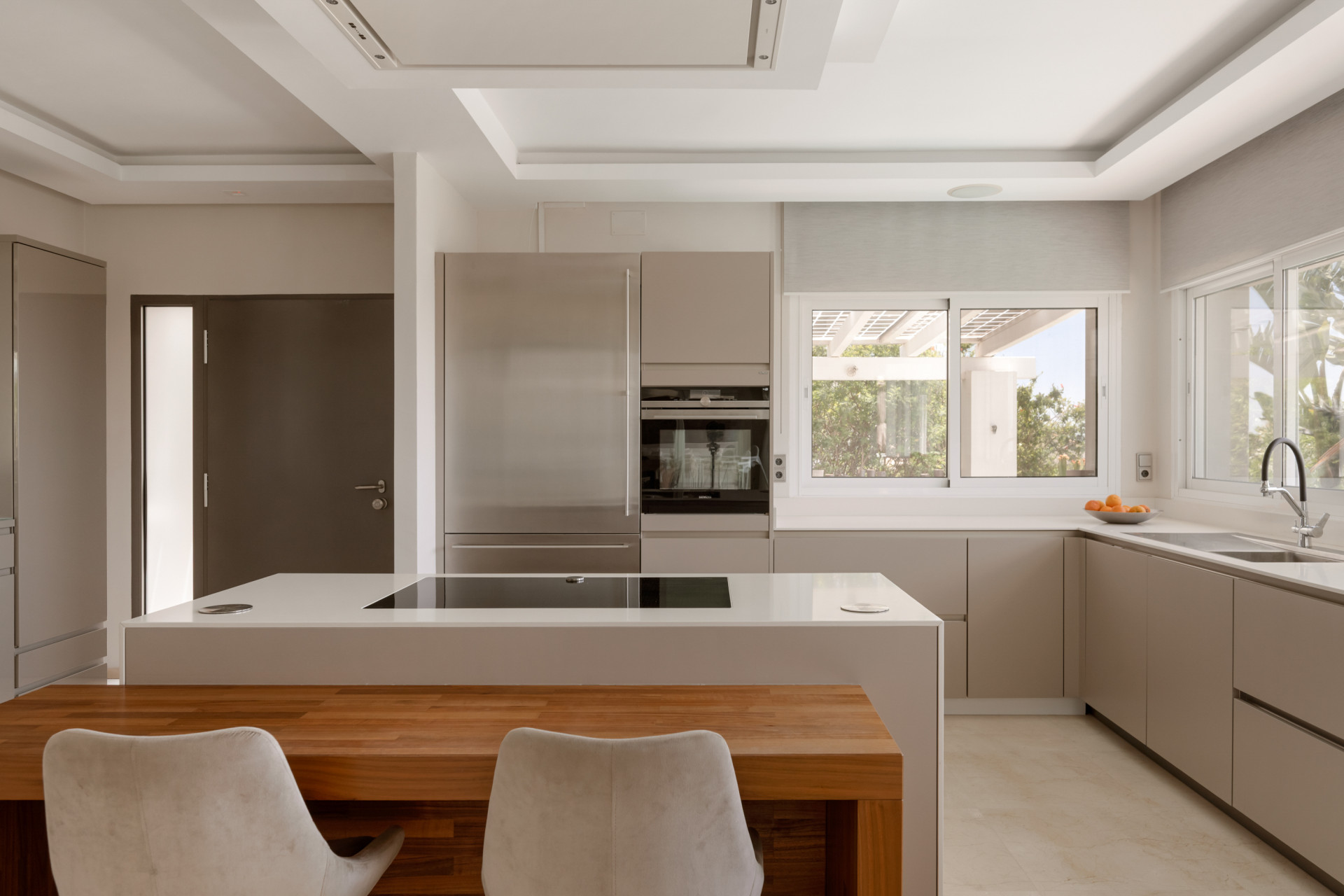 Modern kitchen space showcasing stainless steel appliances and a stylish countertop.