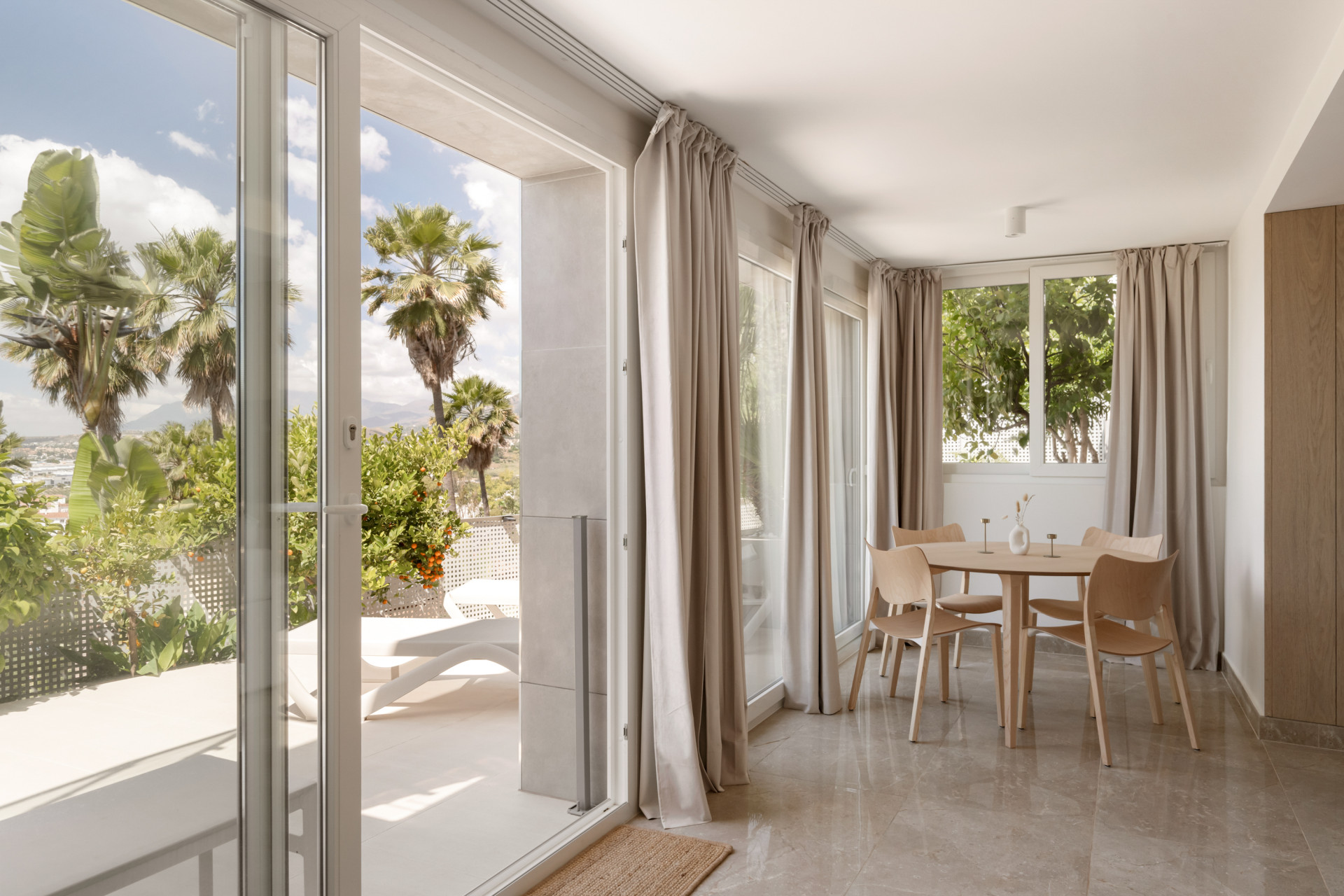 Bright dining space with a round table and garden view.