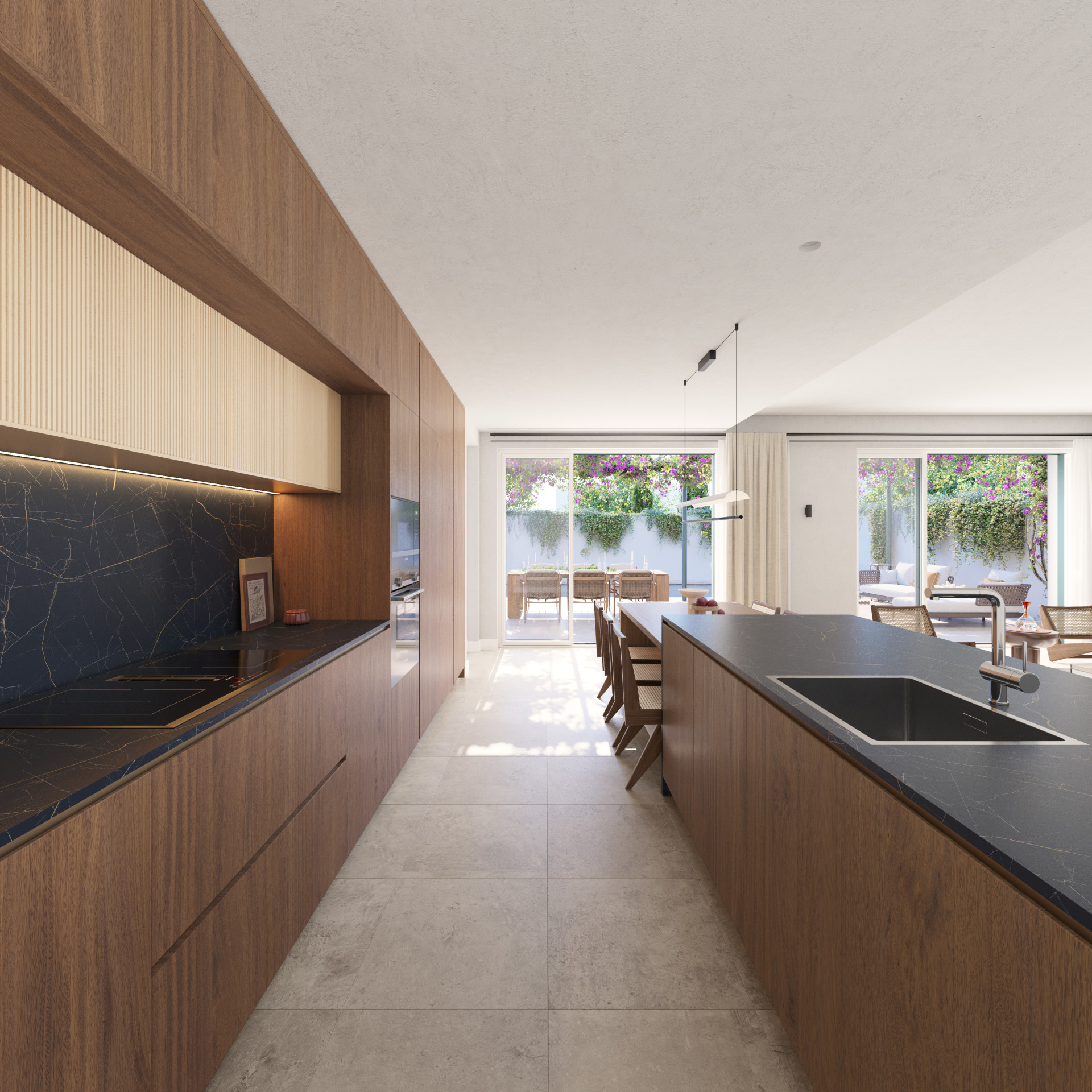 Modern kitchen with wood cabinetry, dark countertops, and island, looking out to an outdoor dining area.