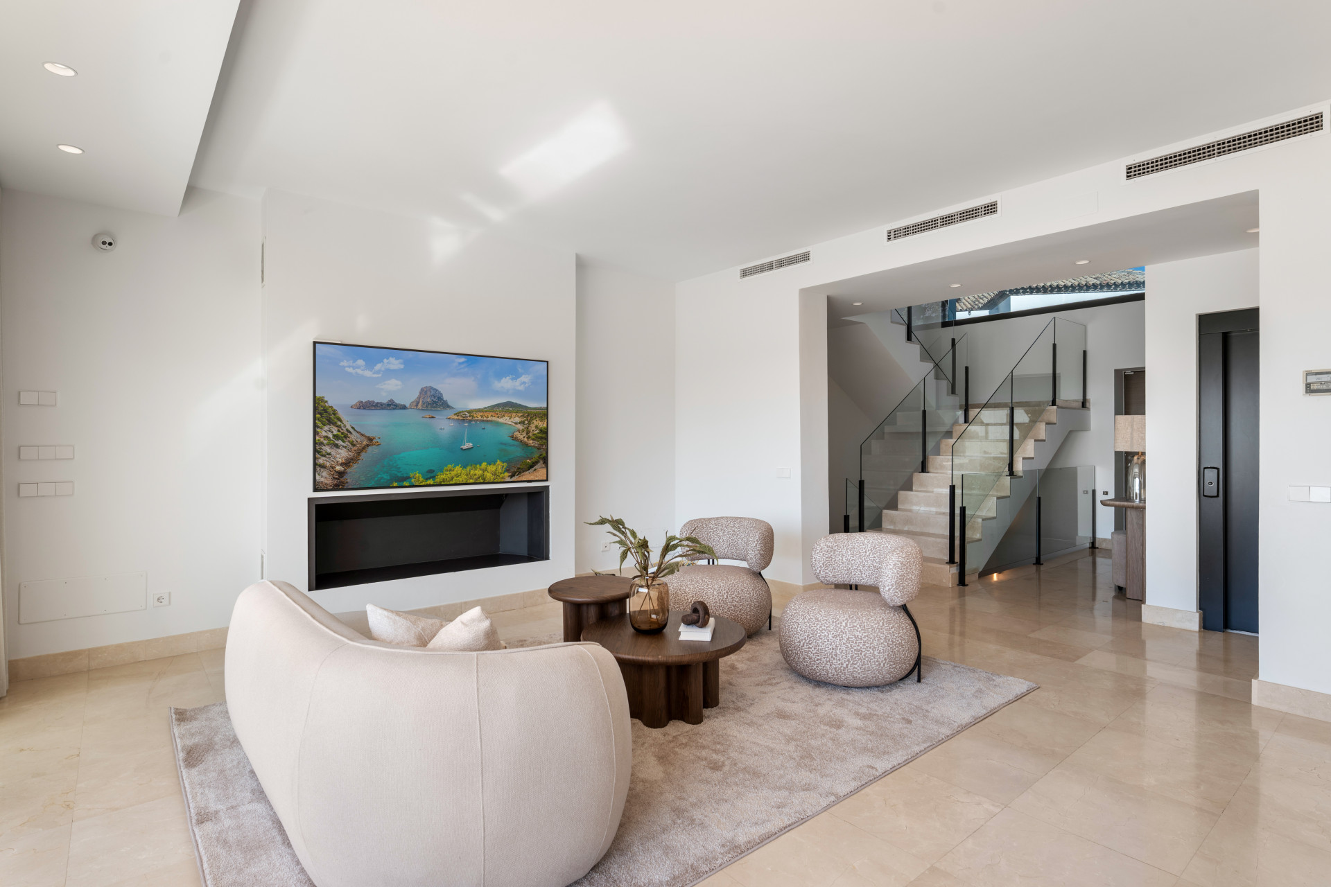 View of the living area with a staircase in the background.