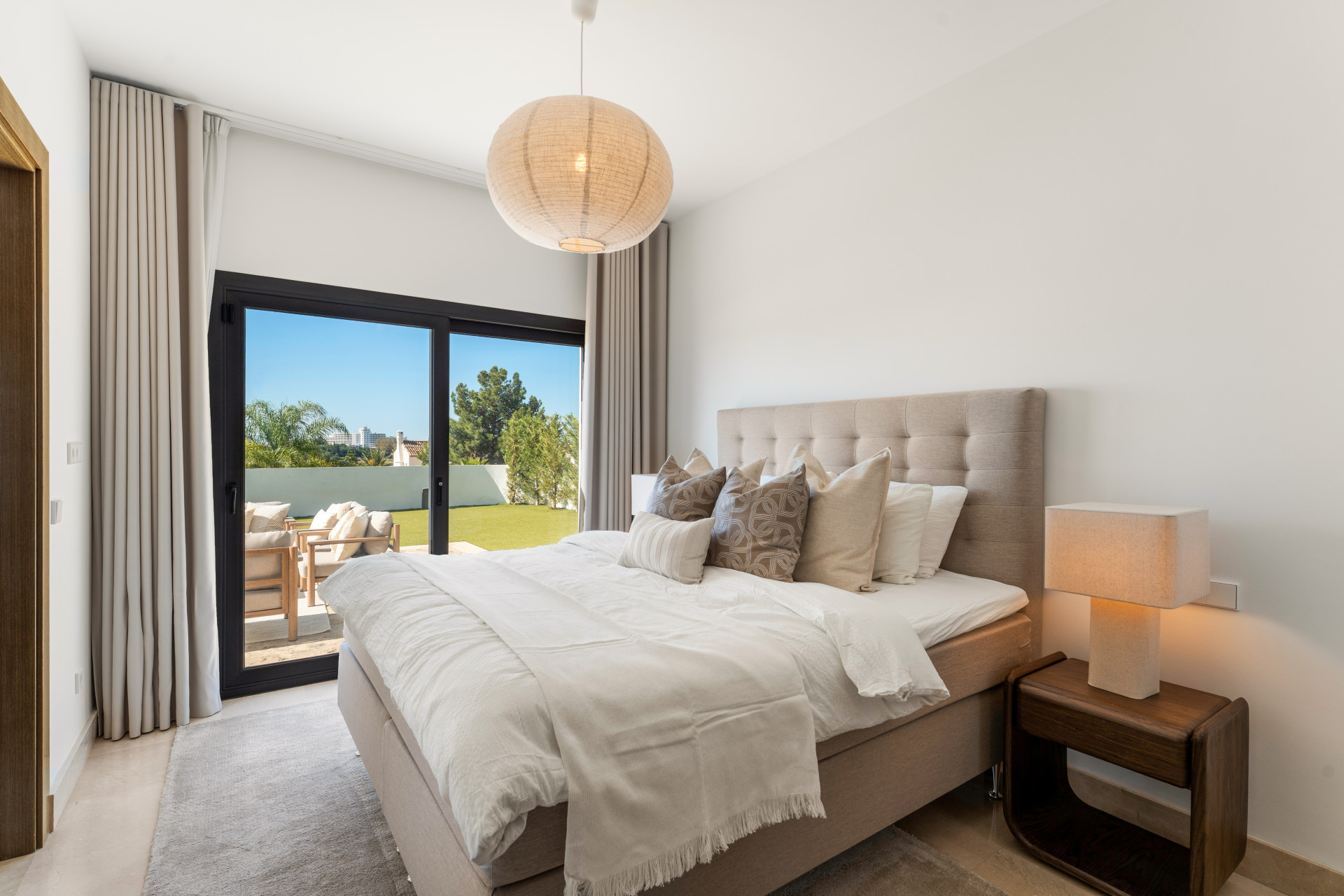 Bright bedroom with a large bed and direct access to an outdoor area.