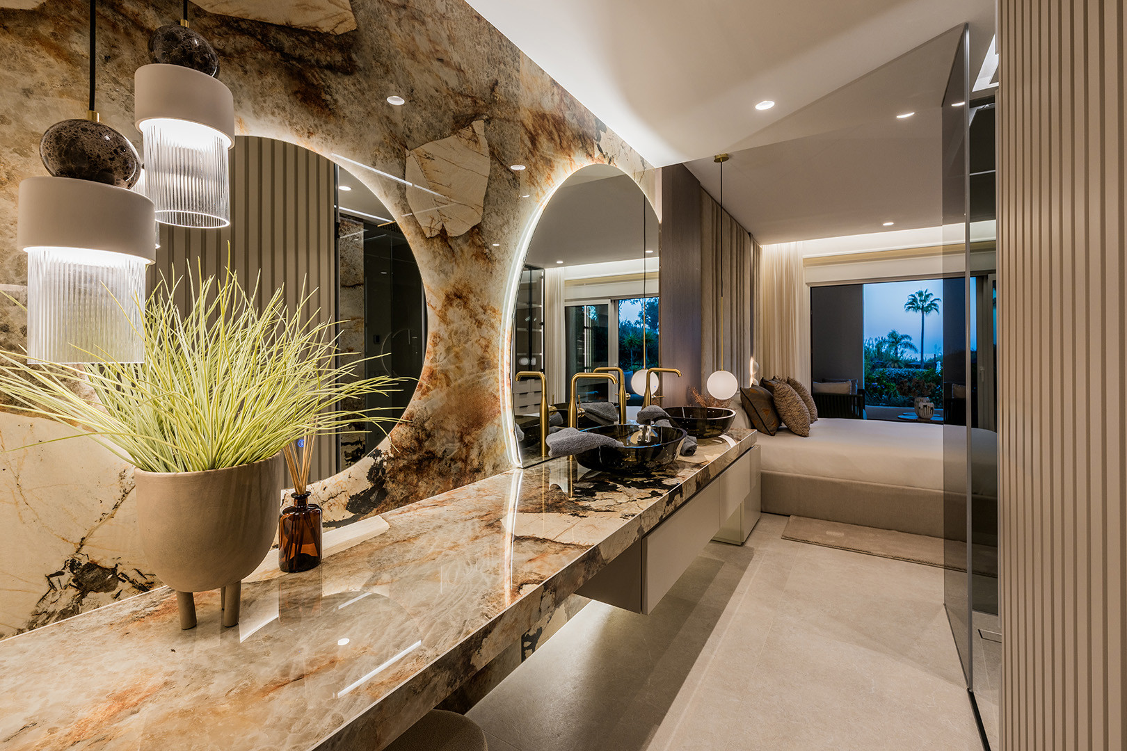 Bathroom vanity with two arched mirrors, two black vessel sinks, and a long marble countertop. Bedroom visible beyond.