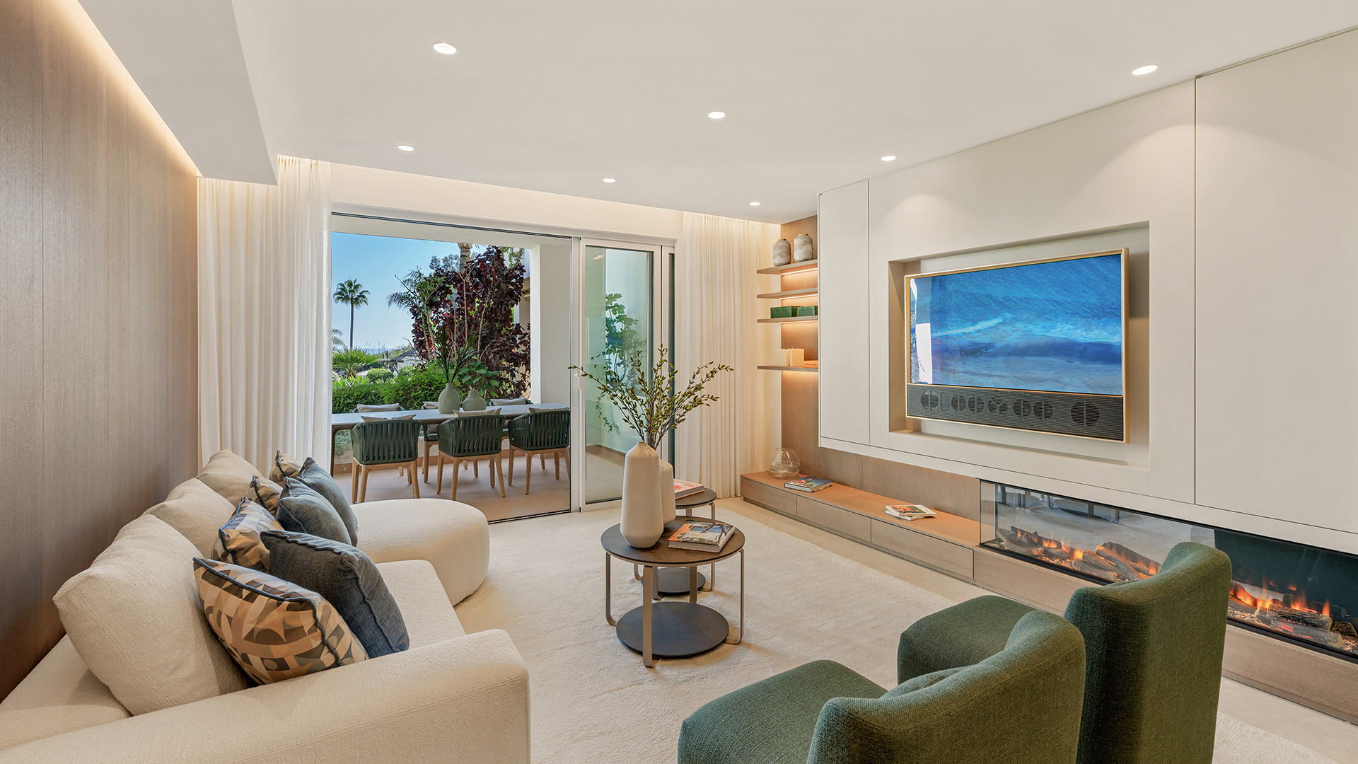 Living room with white sectional, fireplace, and sliding doors to an outdoor dining area.