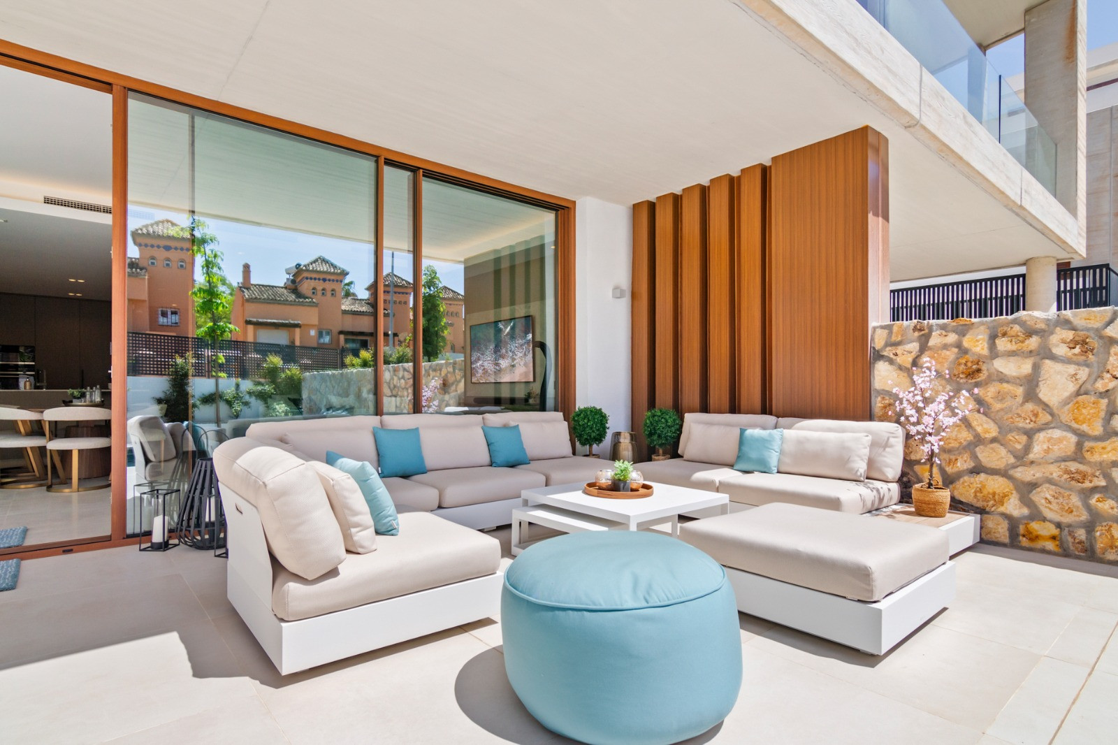 Indoor seating area with large windows overlooking the pool area.
