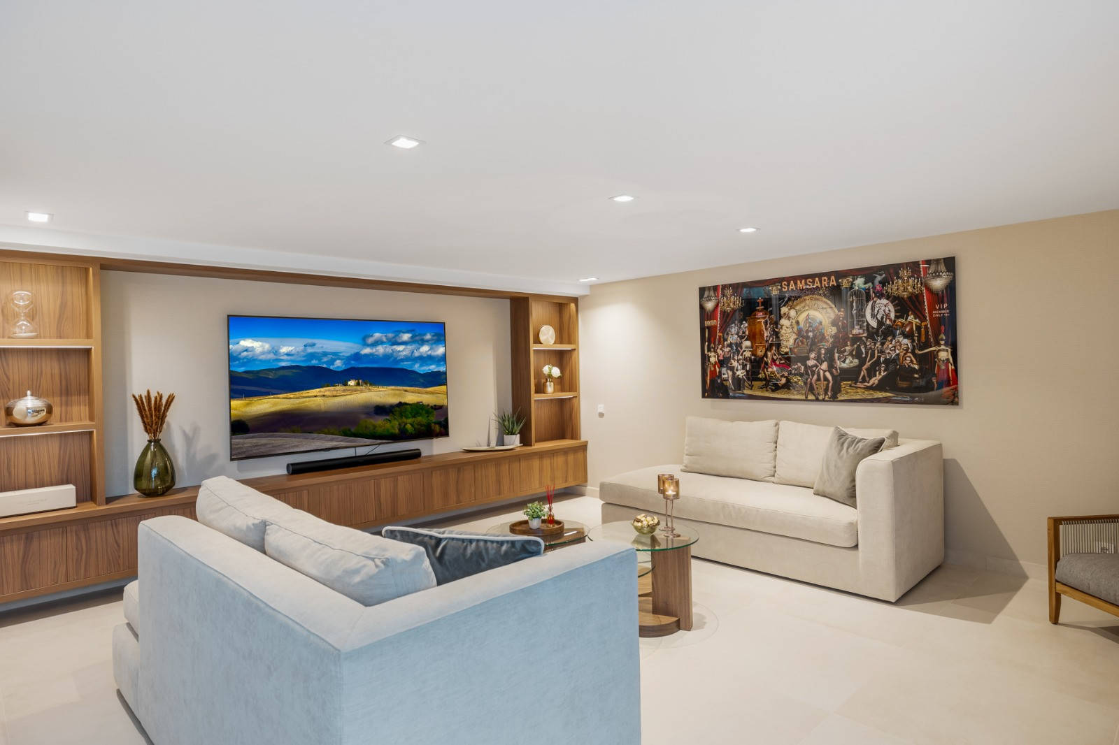 Spacious living room with a TV mounted on wood cabinetry.