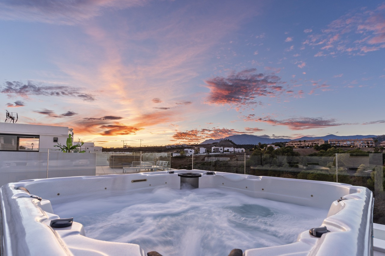 Spa with sunset and mountain backdrop in the distance.