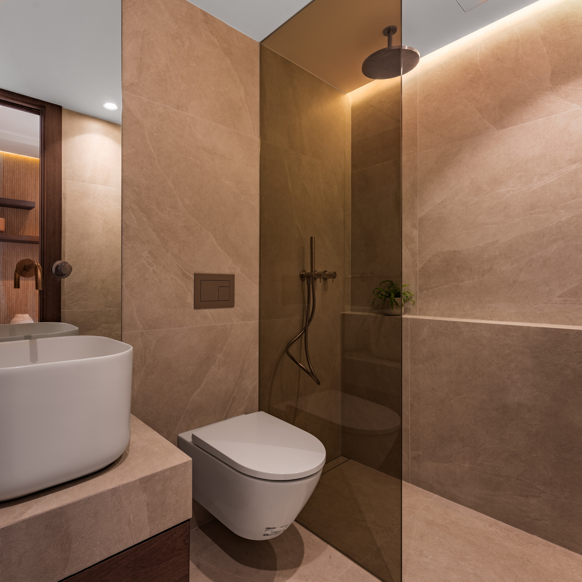 Bathroom with a floating vanity, white vessel sink, wall mounted toilet, and walk-in shower.