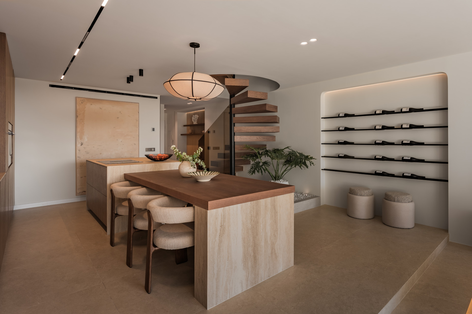 Kitchen island with dining chairs, a spiral staircase, and a dedicated wine wall display.