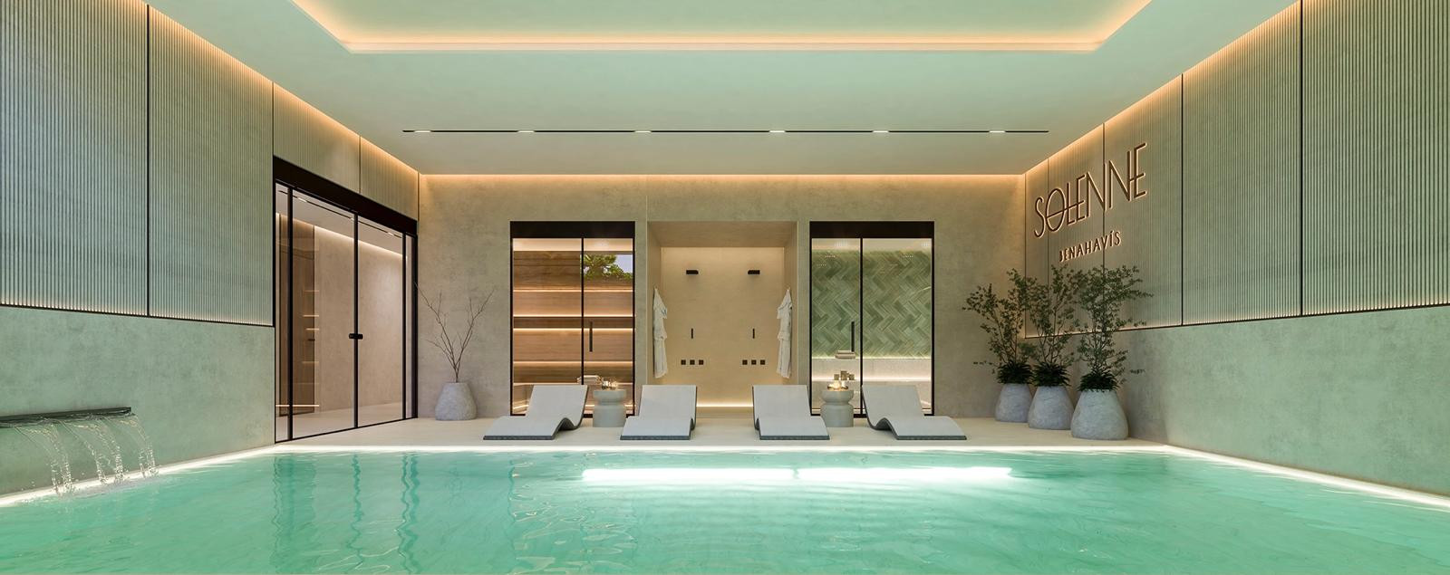 Indoor swimming pool area with several lounge chairs, a water feature, and dark framed doors leading into other rooms.