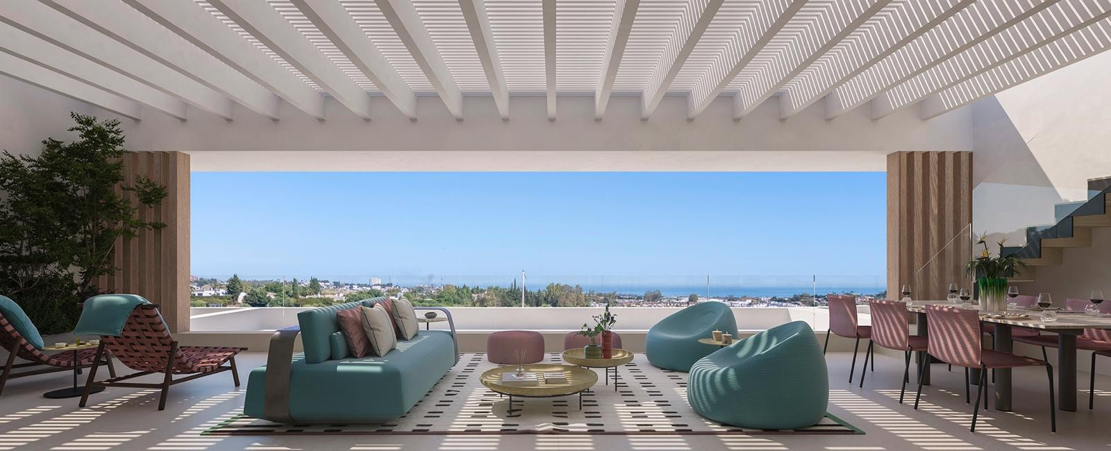 Spacious outdoor living room under a slatted pergola, with colorful furniture, dining area, and distant sea view.