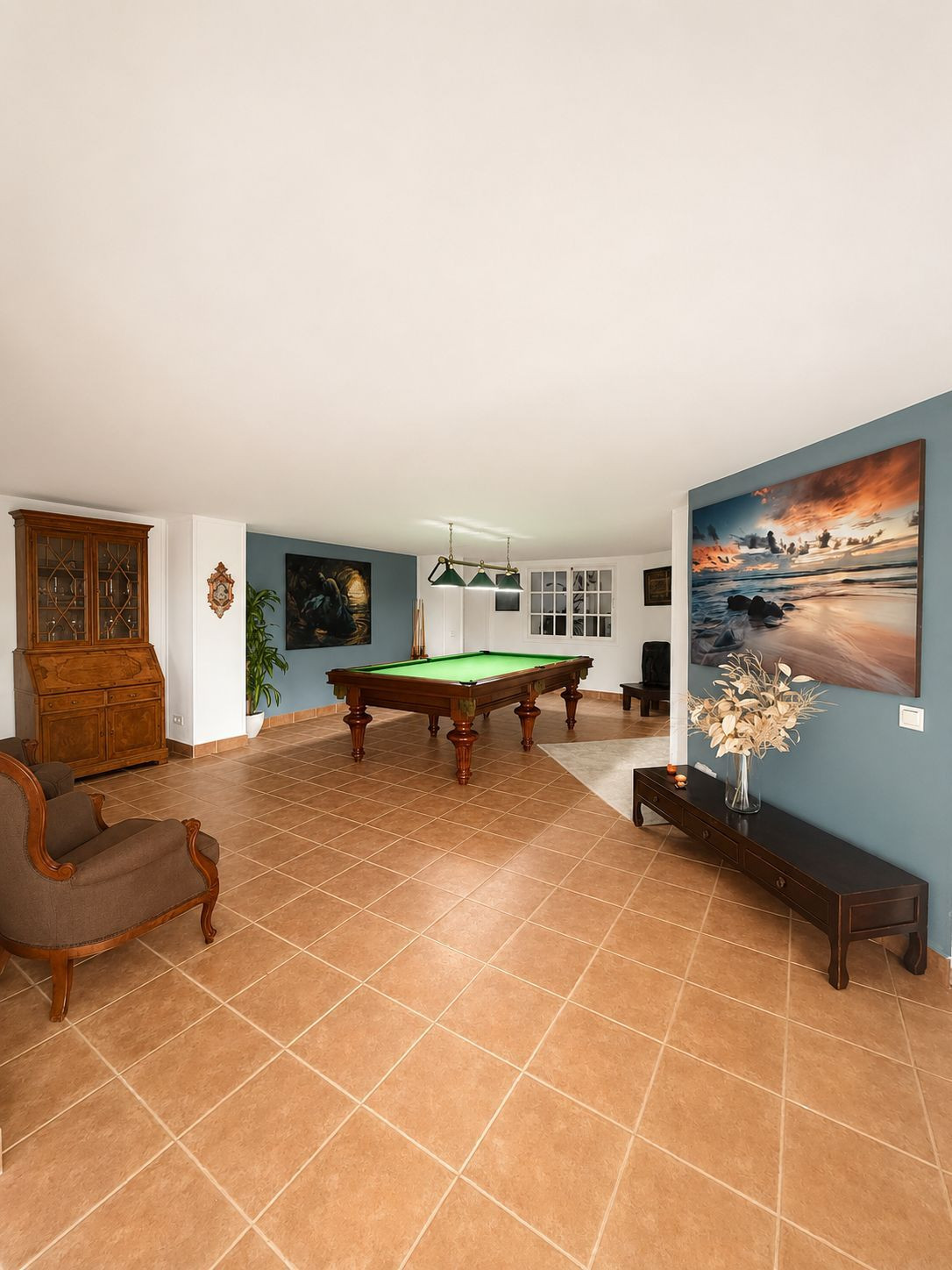 Spacious game room featuring a pool table and seating area.