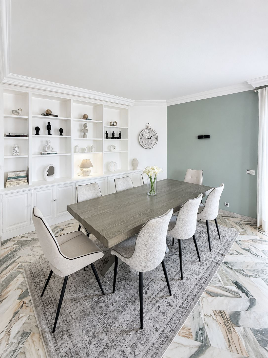 Dining room with a large wooden table and white cabinetry.