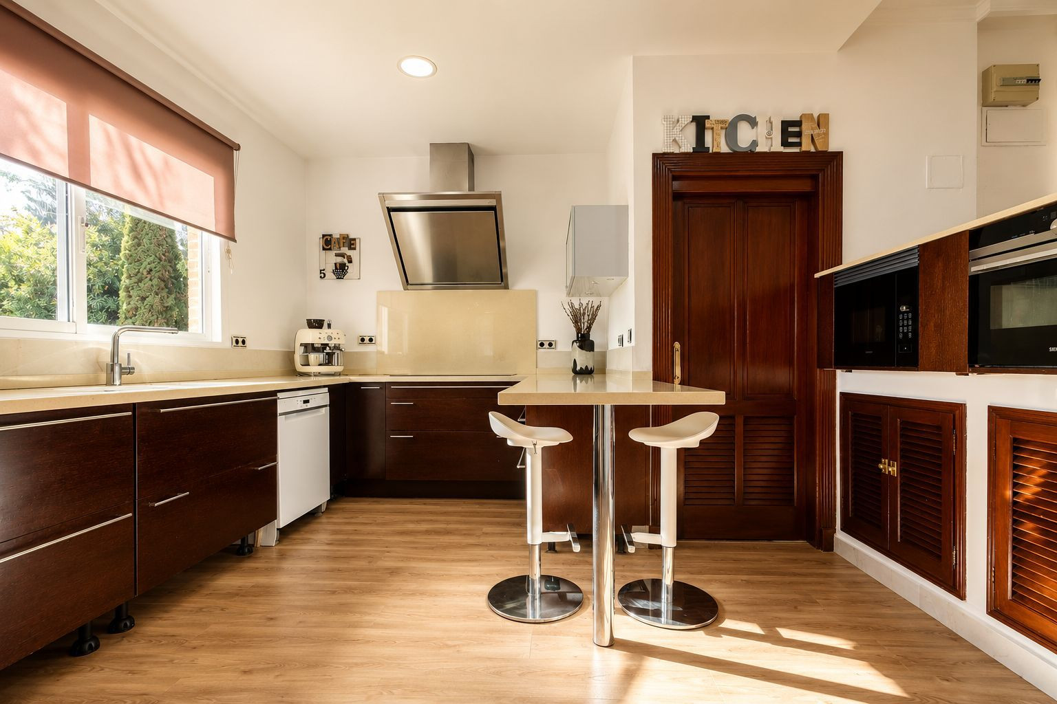 Modern kitchen with sleek cabinetry and bar seating.
