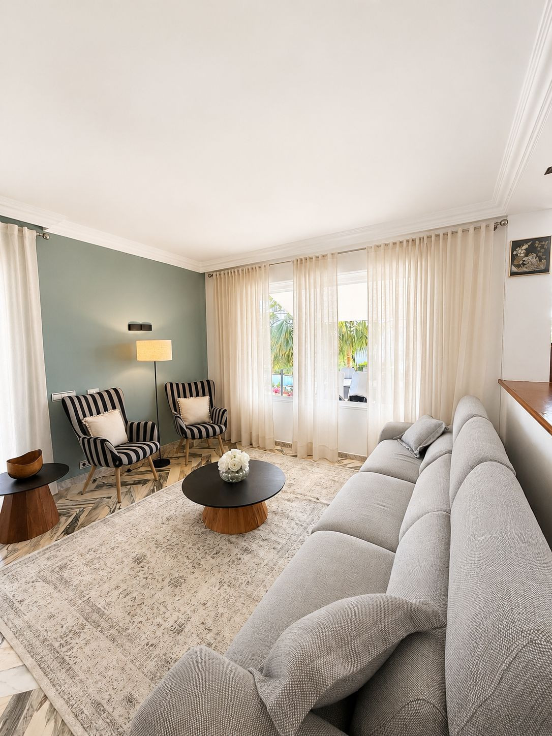 Cozy sitting area with patterned chairs and a round coffee table.